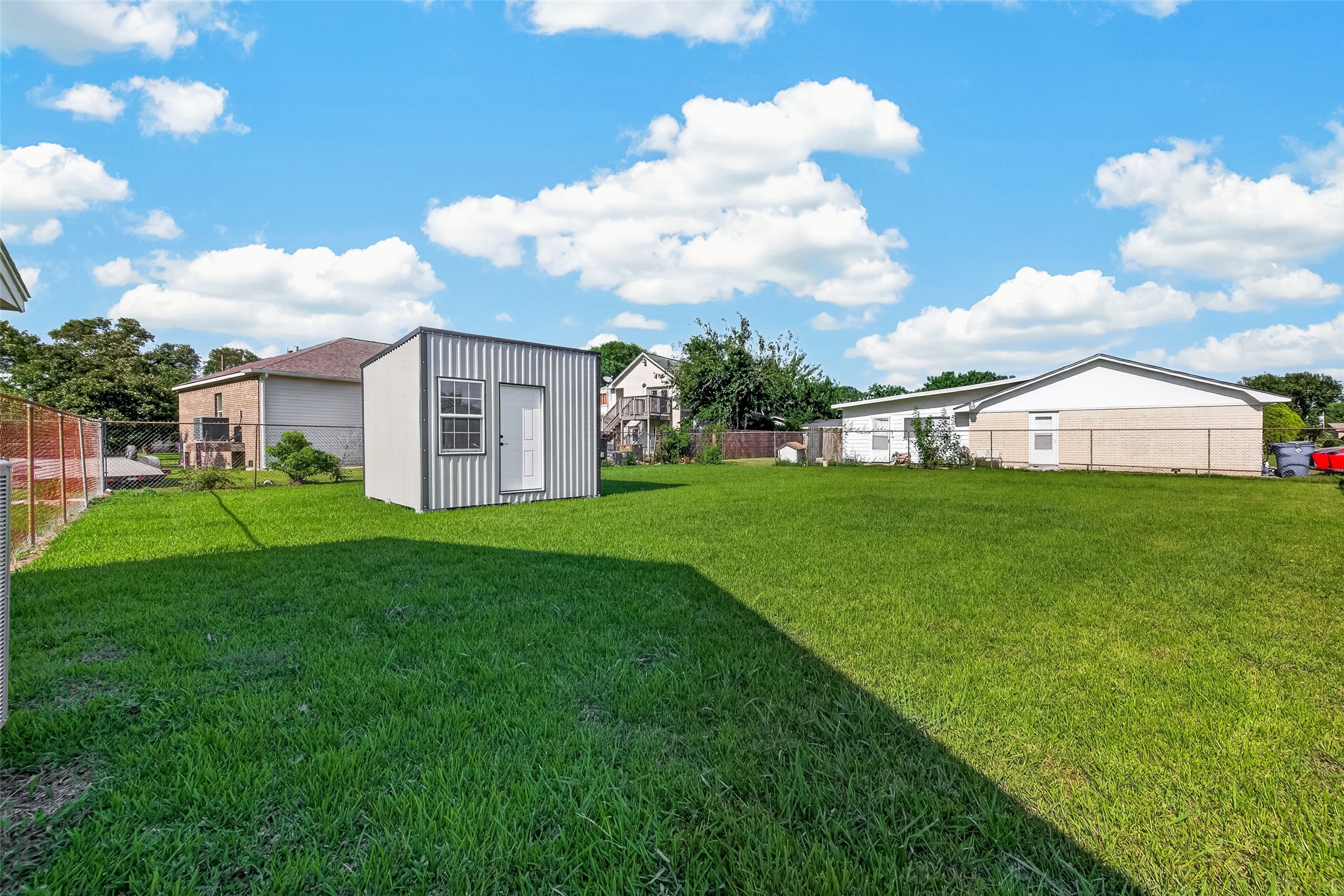 Well-built detached storage shed offering excellent additional space for tools, lawn equipment, seasonal items, workshop, or she-shed. Features durable metal siding, a single-entry door, and a large window that provides abundant natural light. A practical and versatile addition to the property.