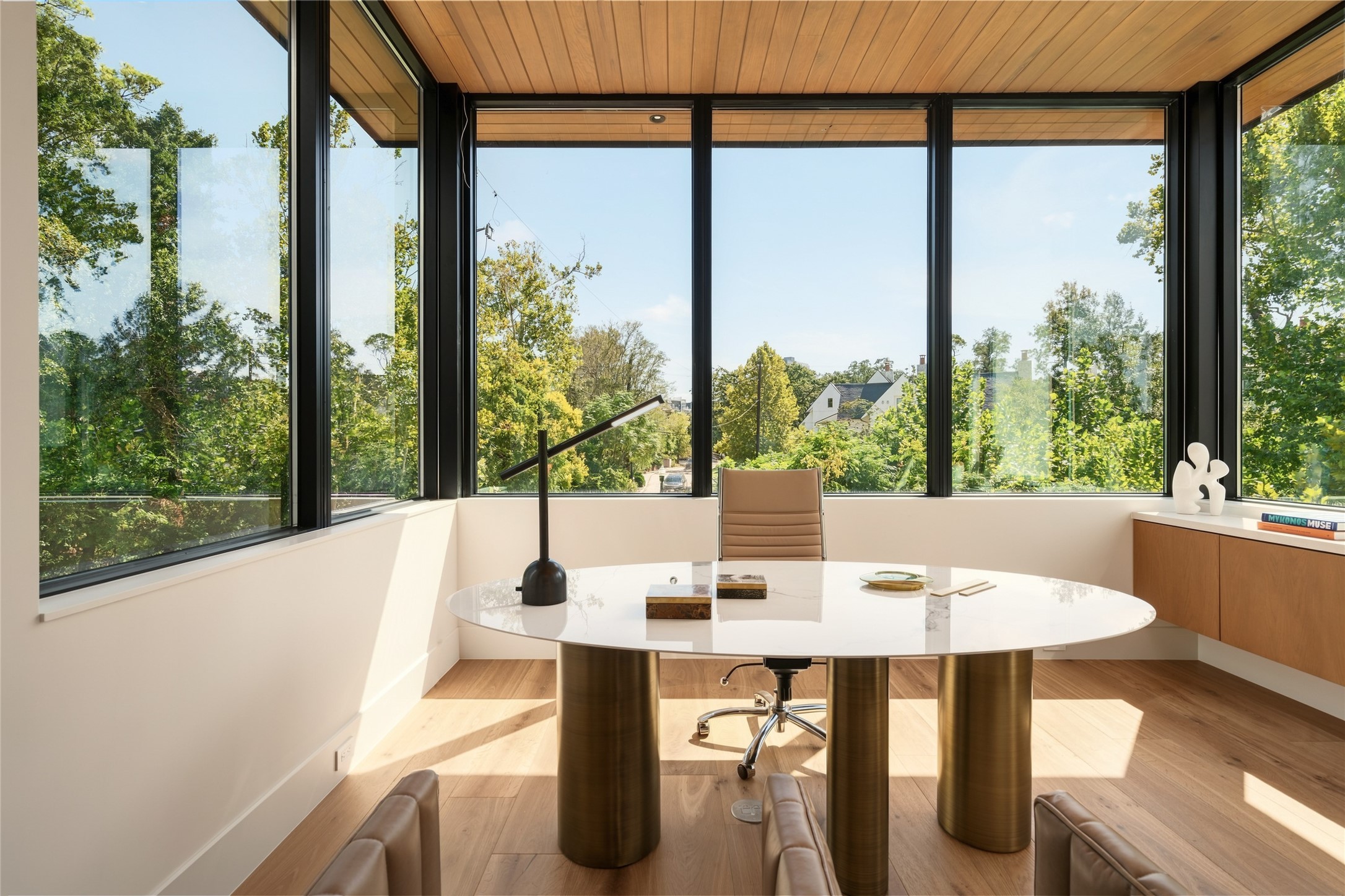 Privately positioned at the far end of the main level, the dedicated study offers a quiet retreat from the home's entertaining spaces, with walls of glass on three sides, custom cabinetry, and sweeping views that make working from home a pleasure.