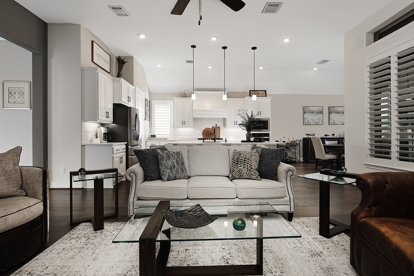 The open-concept floor plan connects the family room, kitchen, and dining area, creating a seamless flow. Each room features a sophisticated color palette that creates a warm and welcoming atmosphere throughout the home.