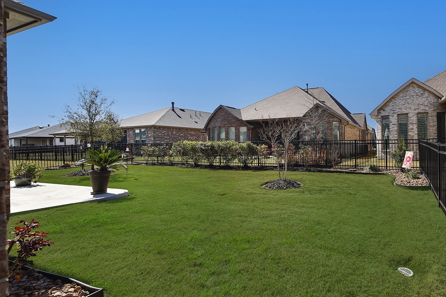 The spacious backyard offers plenty of lawn area, perfect for adding a garden or setting up yard games for when the grandkids visit.