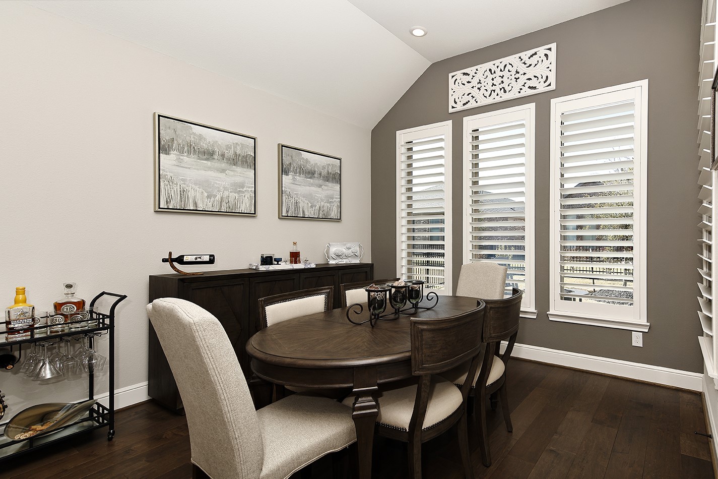 This spacious dining room features plantation shutters overlooking the backyard providing an ideal setting for hosting family and friends around a large table.