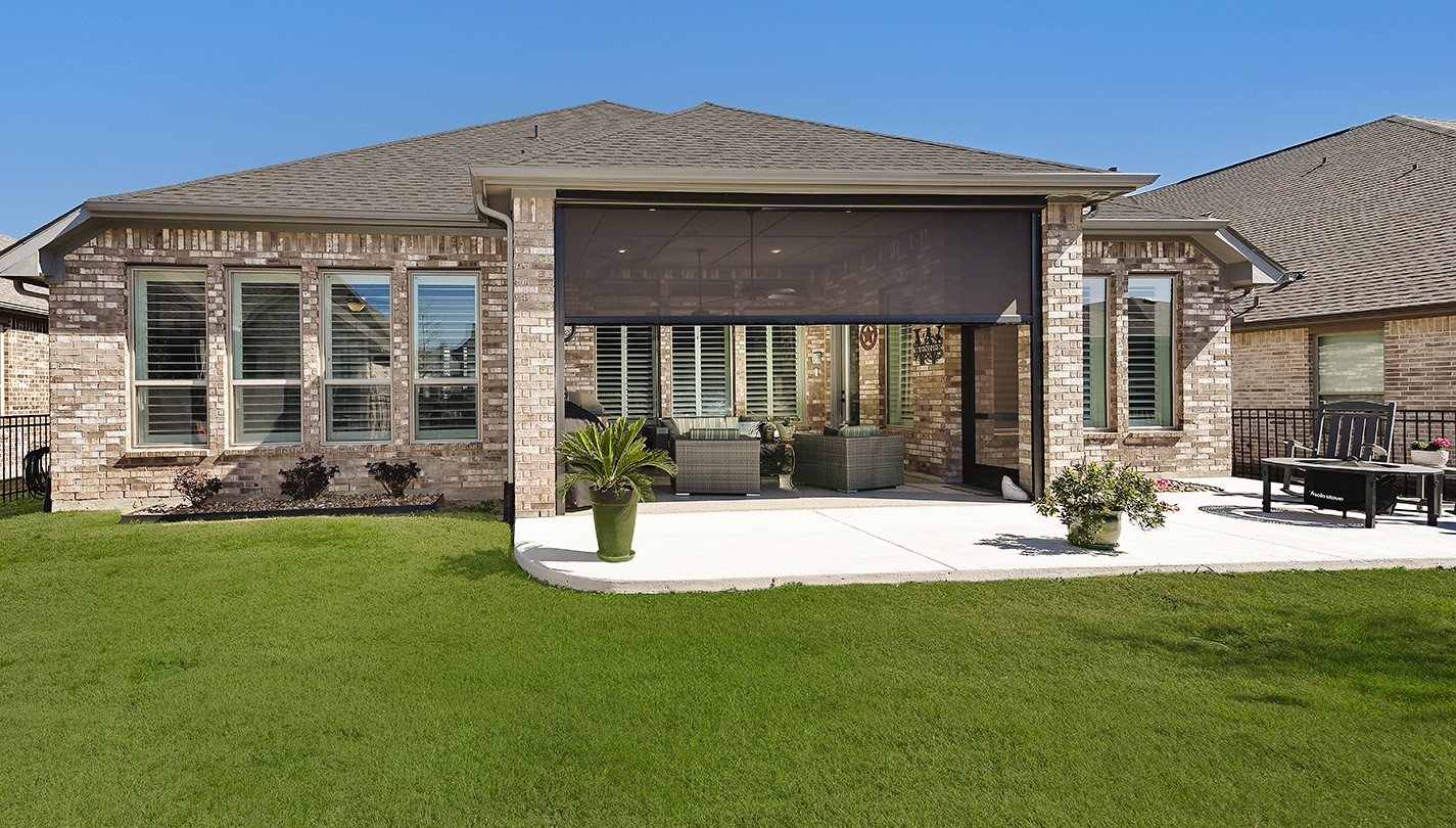 This stunning home features full brick construction on all sides and expansive, floor-to-ceiling windows that span the entire rear elevation.