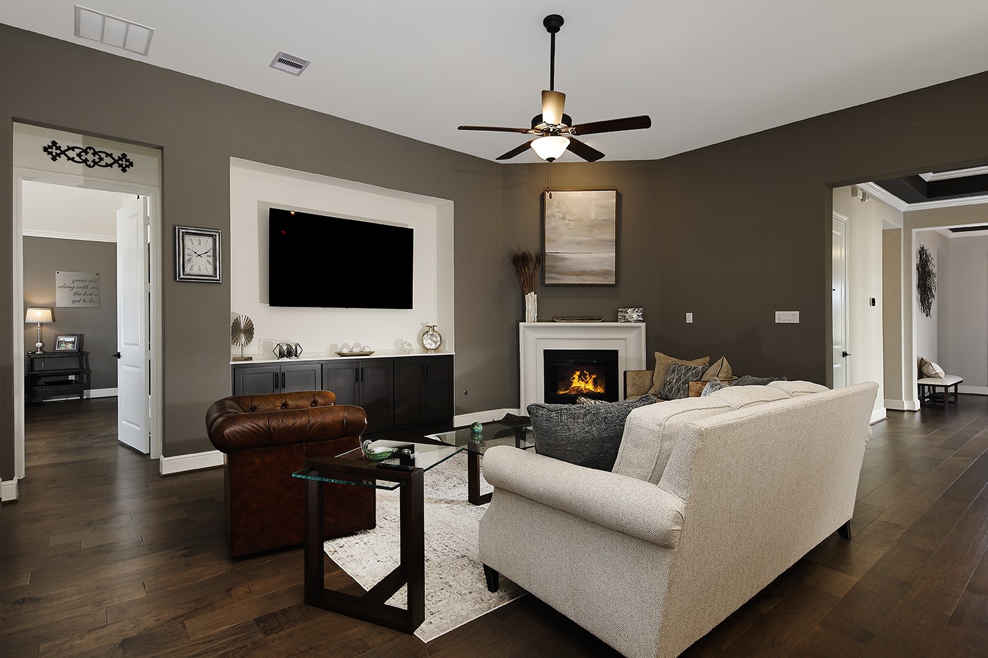 S Spacious family room featuring an inviting ambiance, a cozy gaslog fireplace, and ample space for a comfortable seating arrangement perfect for relaxing or entertaining guests.