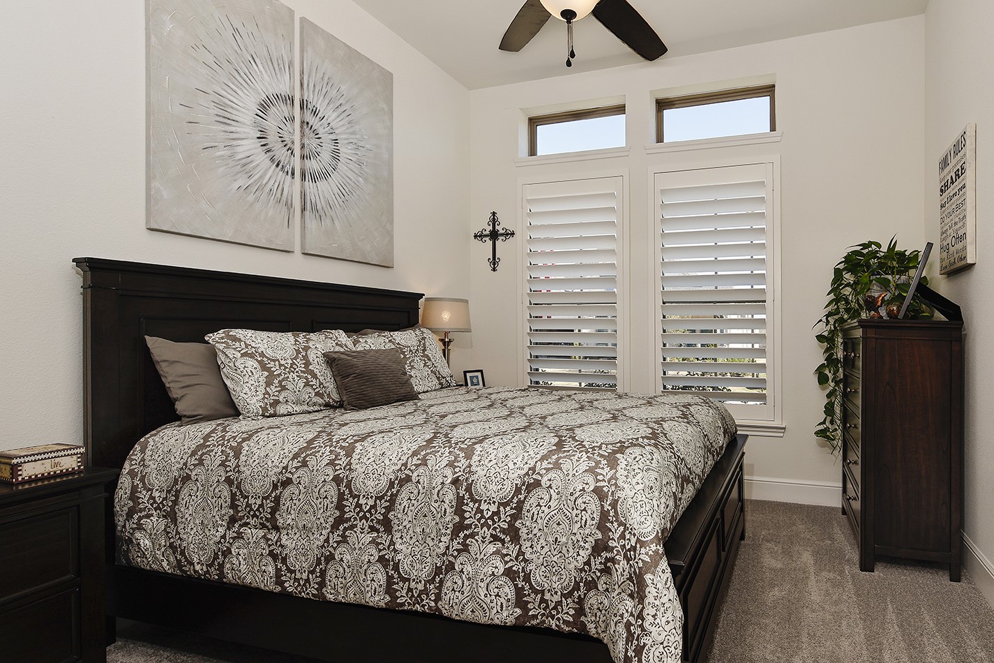 Bedroom two has neutral wall colors to go with any decor, ample room for a large bed and dressers, enhanced by plantation shutters and elegant transom windows.
