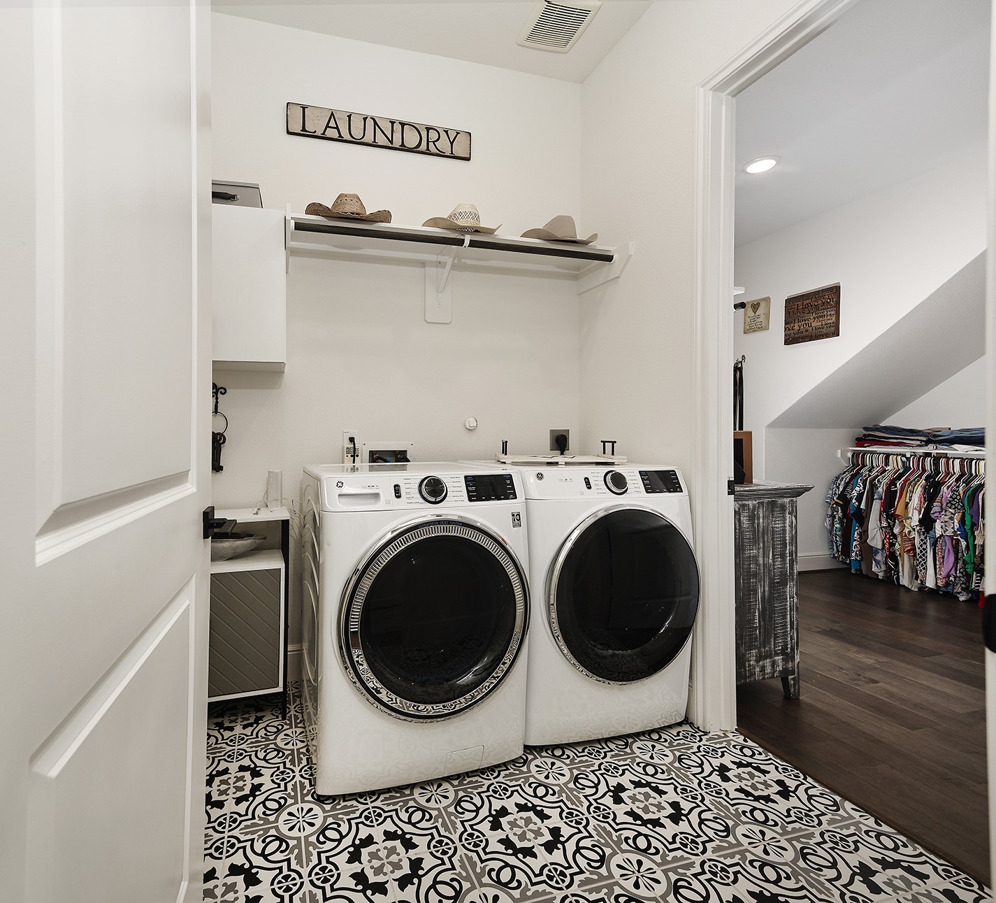 Functional and convenient layout featuring a walk-through laundry room with dual access points from the primary closet and the secondary bedrooms hallway.