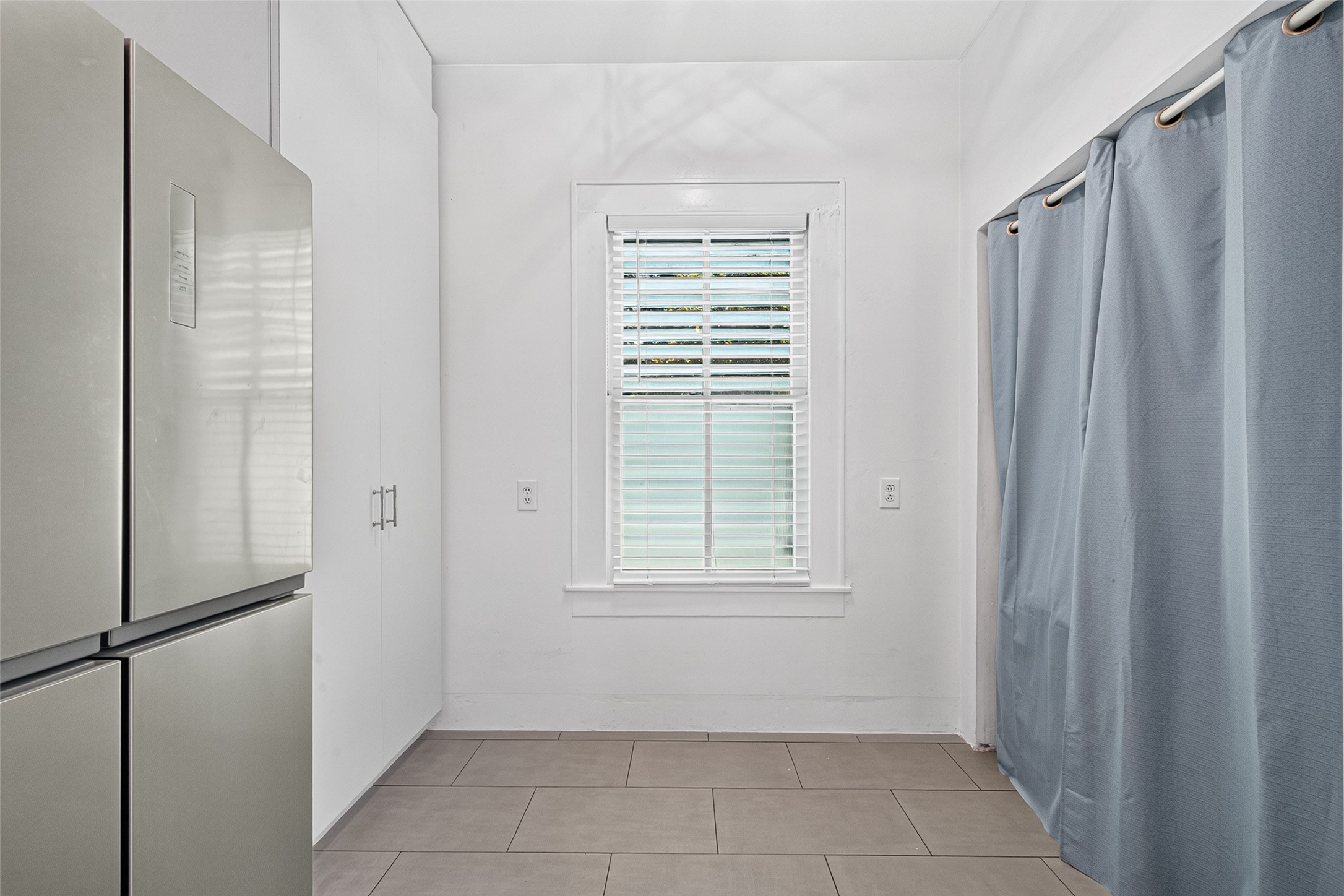 FRIDGE, PANTRY, AND "ALL IN ONE" WASHER DRYER COMBO ON THE RIGHT