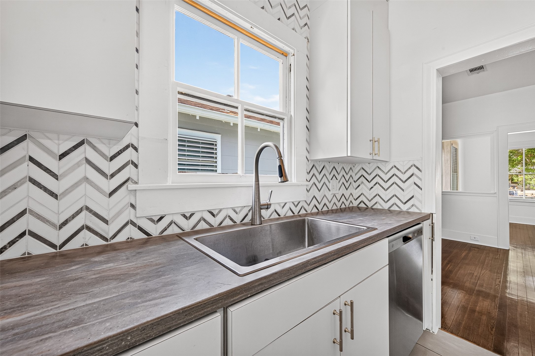 KITCHEN- DEEP SINK, CORIAN COUNTER TOPS, MOSAIC BACKSPLASH, NEW DISHWASHER AND PULLS, LOTS OF NATURAL LIGHT