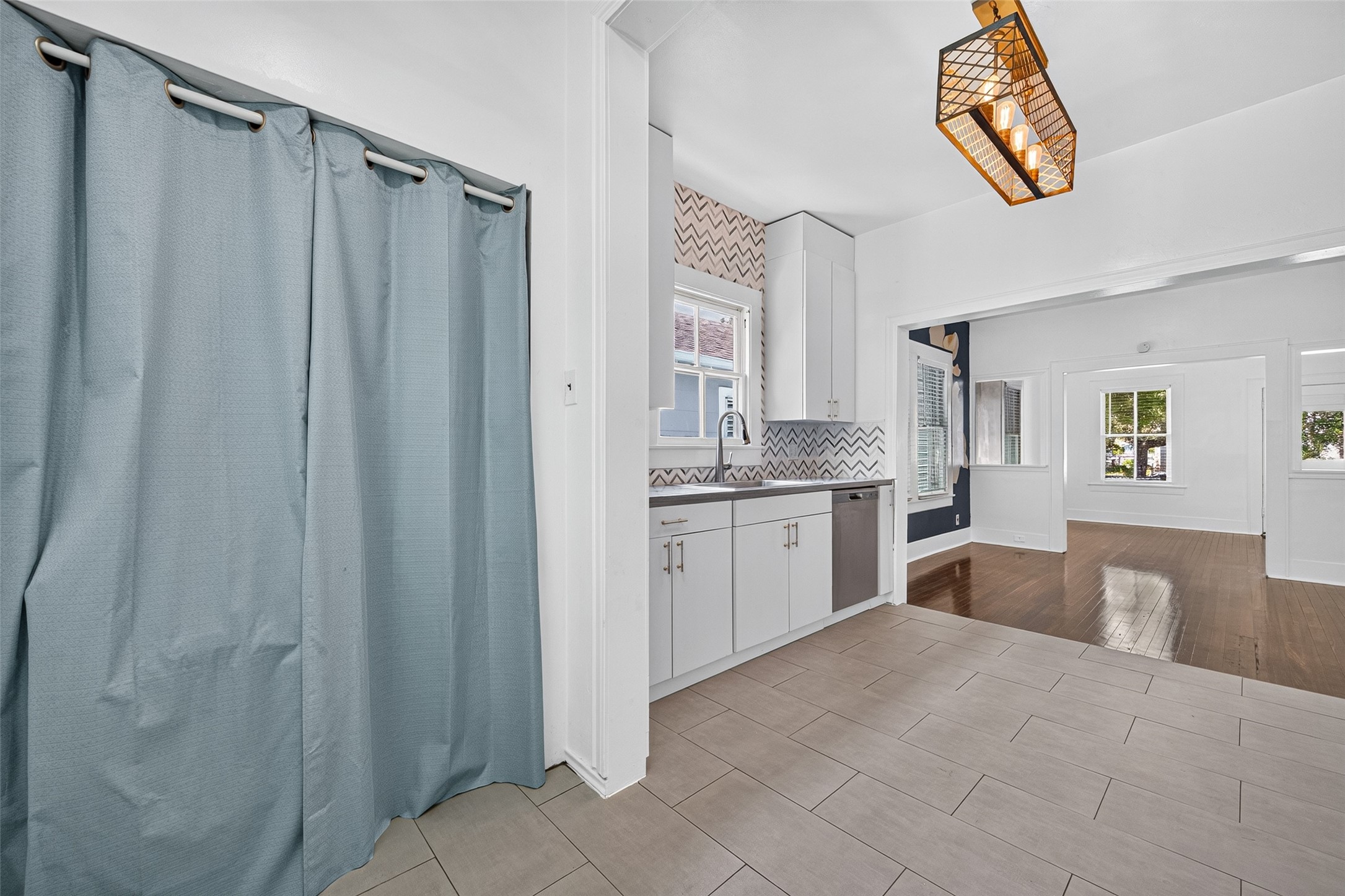 UTILITY- ALL IN ONE WASHER DRYER BEHIND CURTAIN