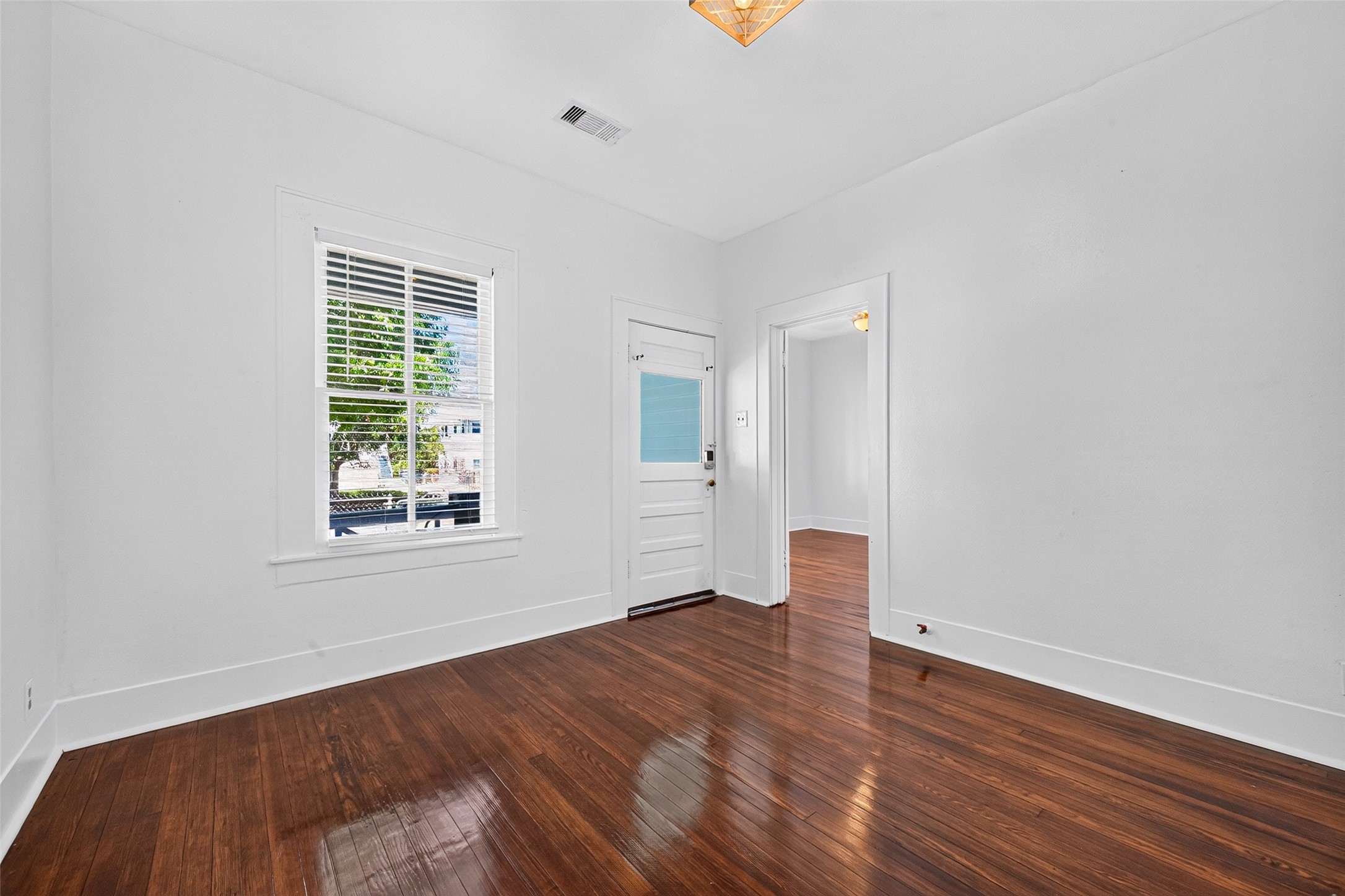LIVING ROOM LOOKING TOWARD FRONT PORCH/FRONT BEDROOM. GORGEOUS HARDWOOD FLOORS! LOTS OF NATURAL LIGHT