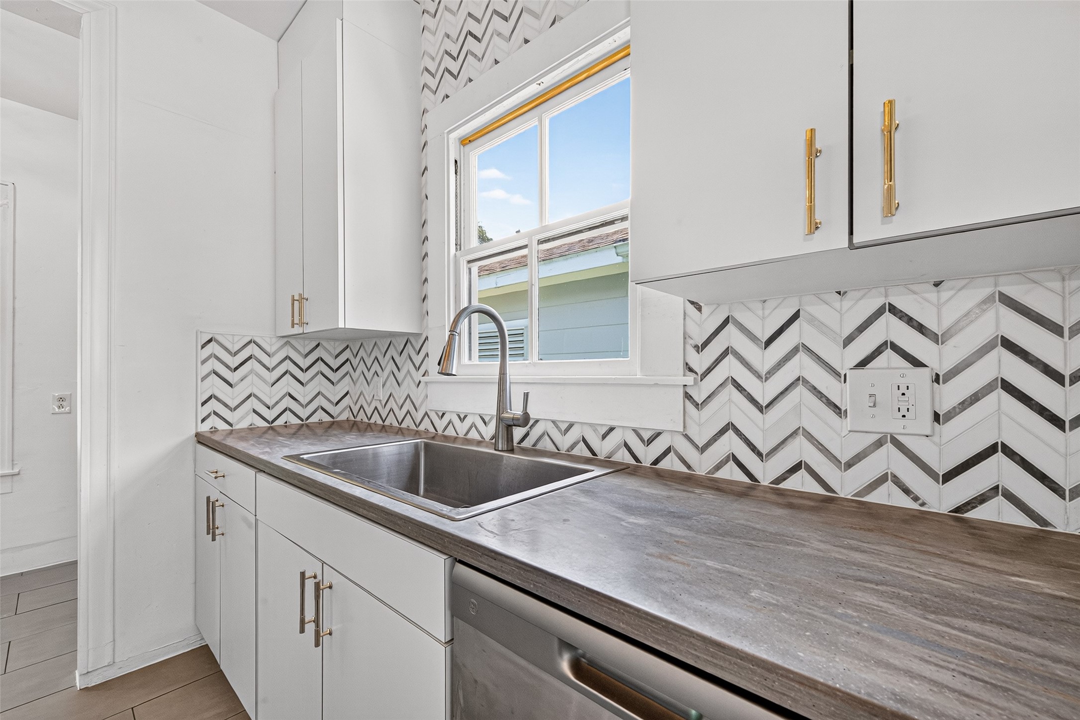 KITCHEN- DEEP SINK, CORIAN COUNTER TOPS, MOSAIC BACKSPLASH, NEW DISHWASHER AND PULLS, LOTS OF NATURAL LIGHT