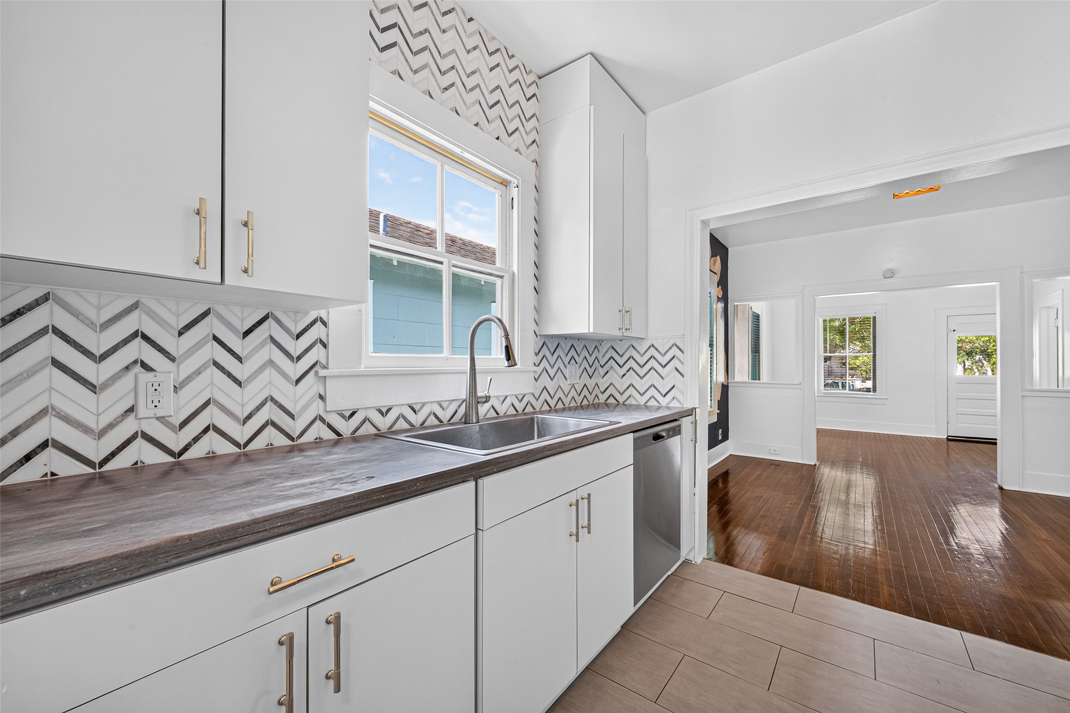 KITCHEN- DEEP SINK, CORIAN COUNTER TOPS, MOSAIC BACKSPLASH, NEW DISHWASHER AND PULLS, LOTS OF NATURAL LIGHT