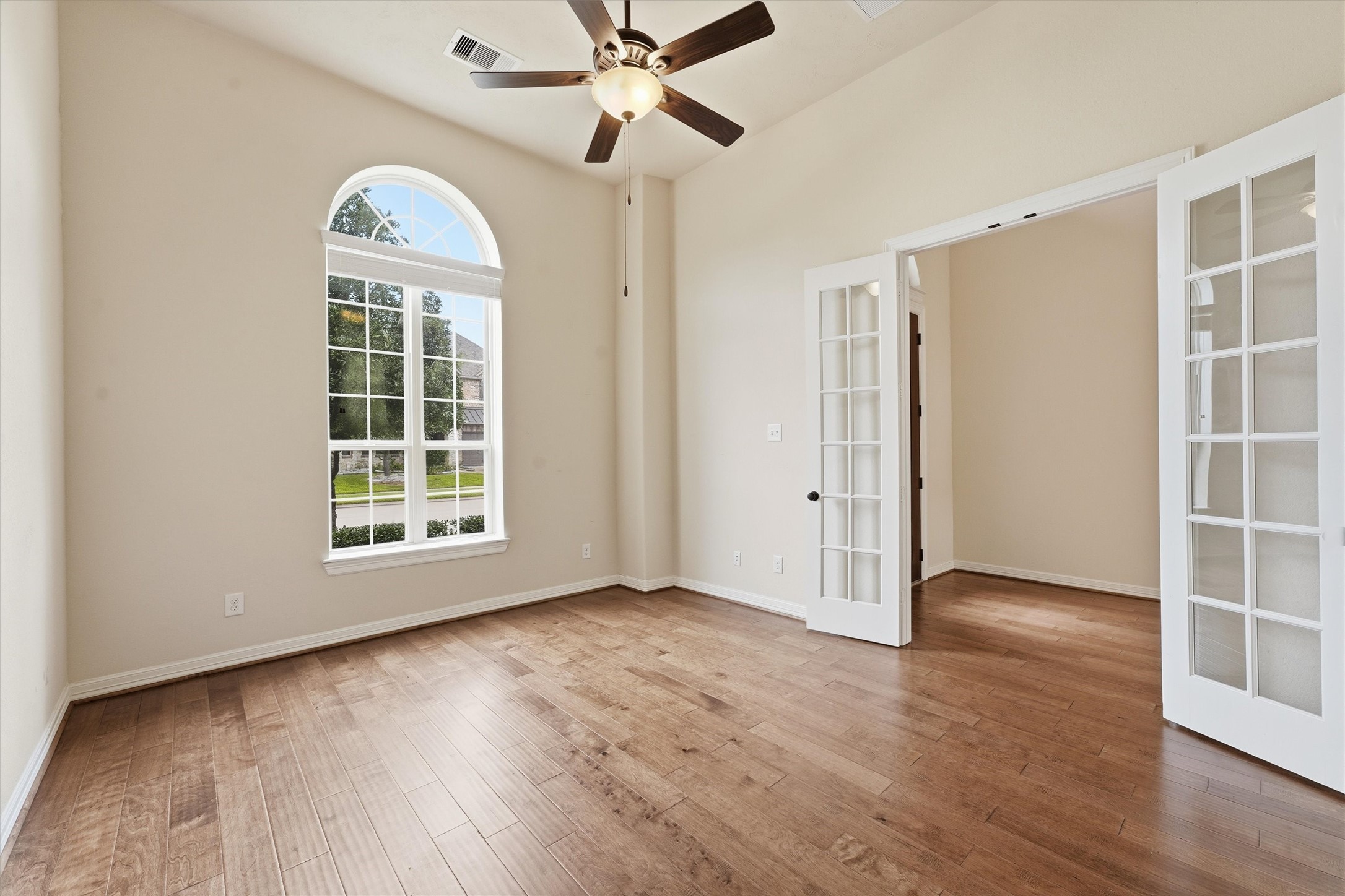 Just right of the foyer is the home office with french doors