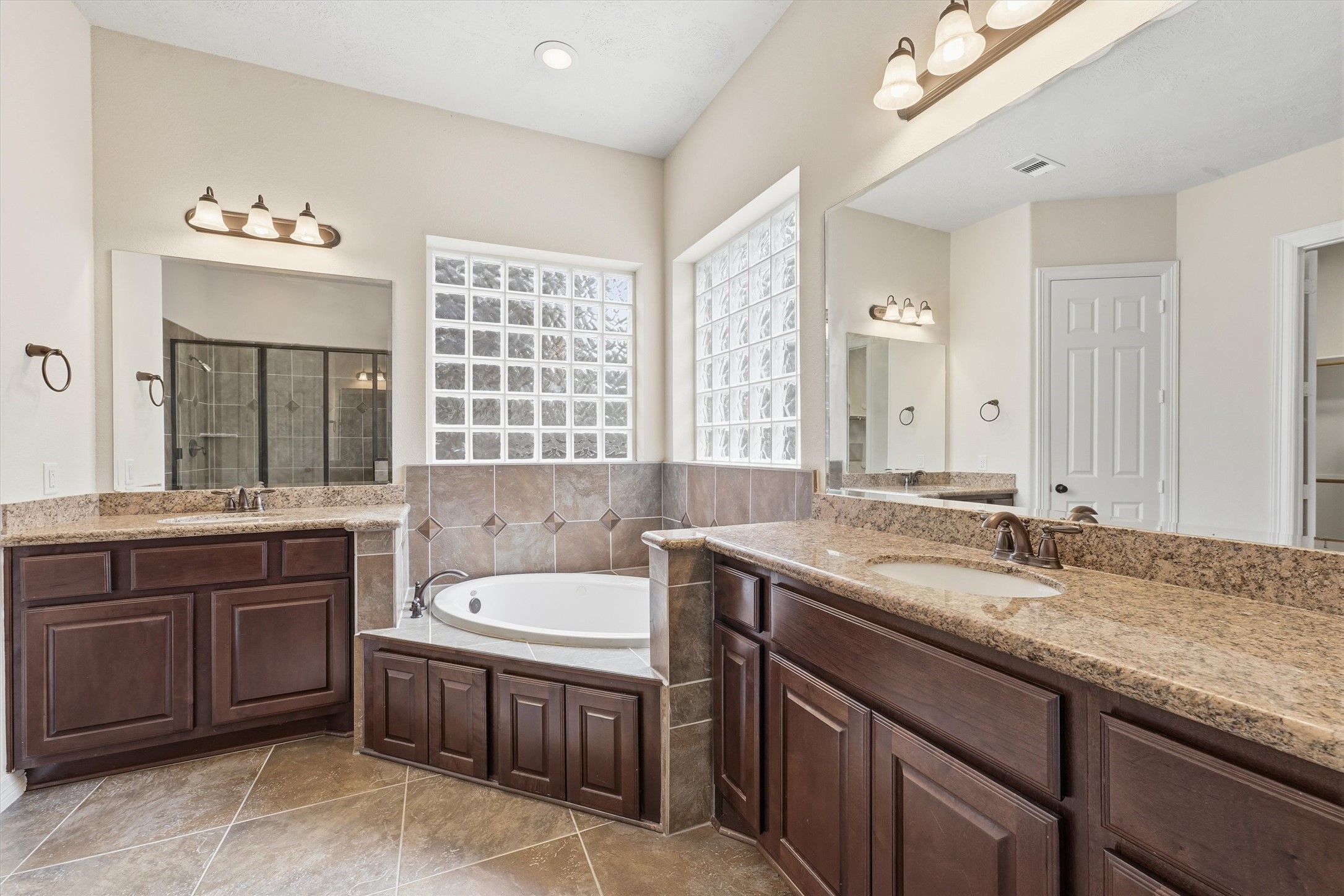 Primary ensuite bathroom with double vanities, large soaking tub and seperate walk-in shower