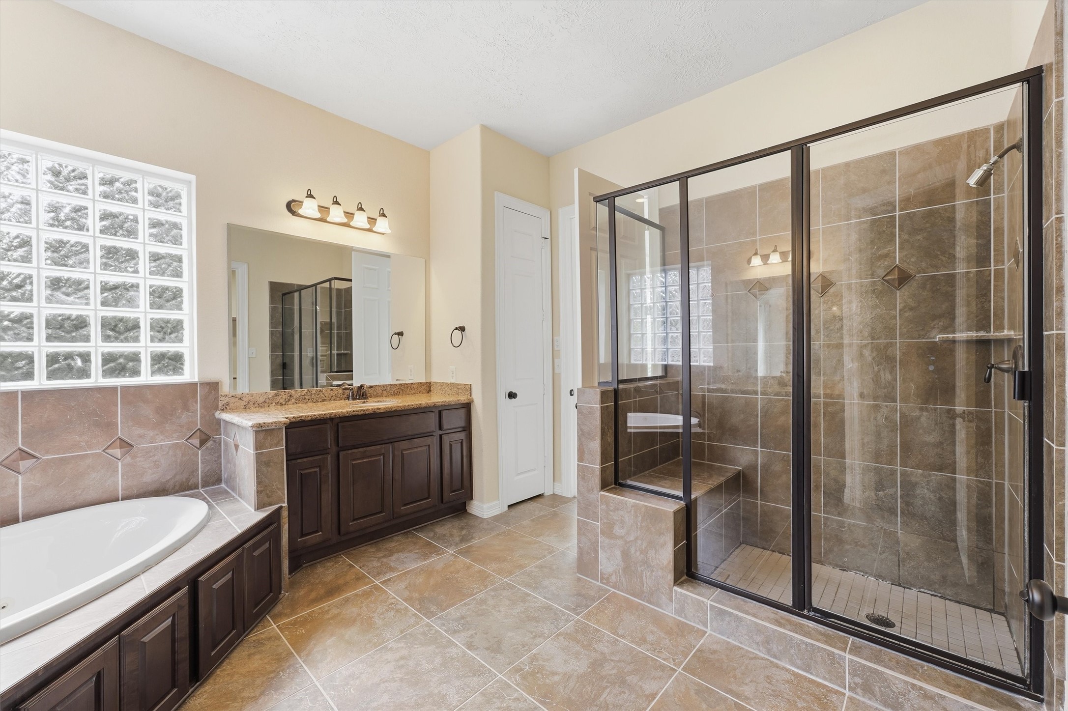 Primary ensuite bath with double vanities, a large soaking tub and seperate walk-in shower