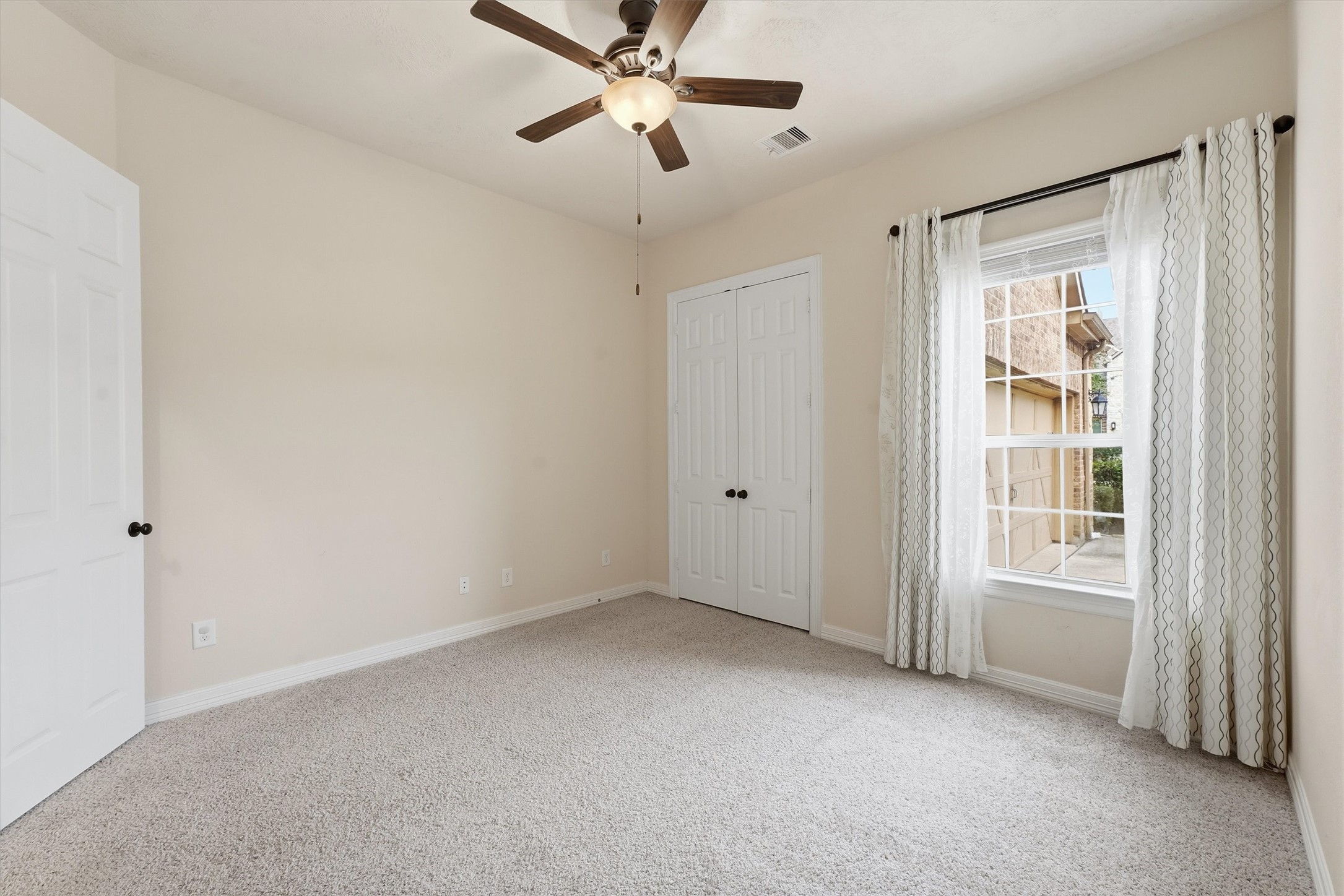 Bedroom #2 is downstairs, features a large closet and tons of natural light.  Full bath is just across the hall.