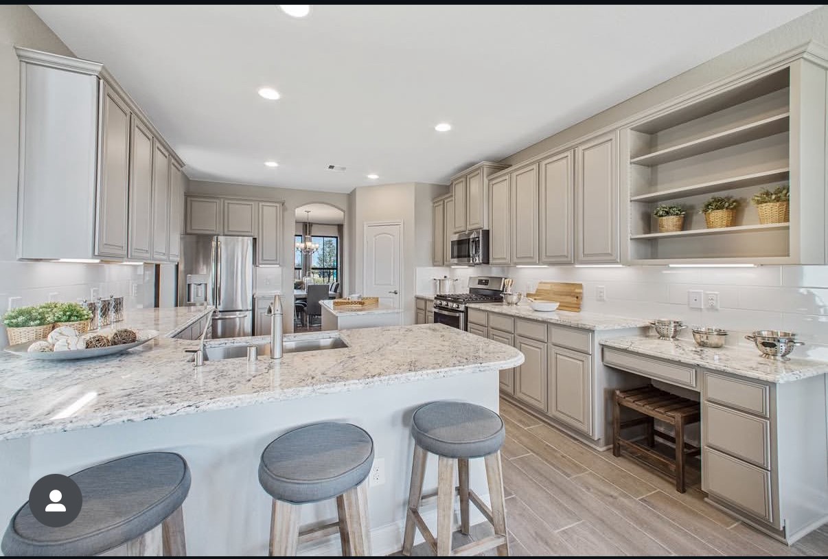 Spacious kitchen featuring granite countertops, stainless steel appliances, and ample cabinetry, perfect for culinary enthusiasts.