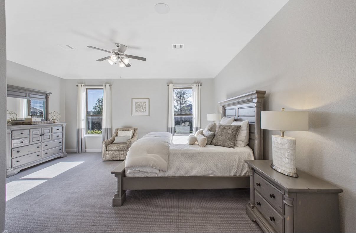 Spacious and bright bedroom with large windows that fill the room with natural light.