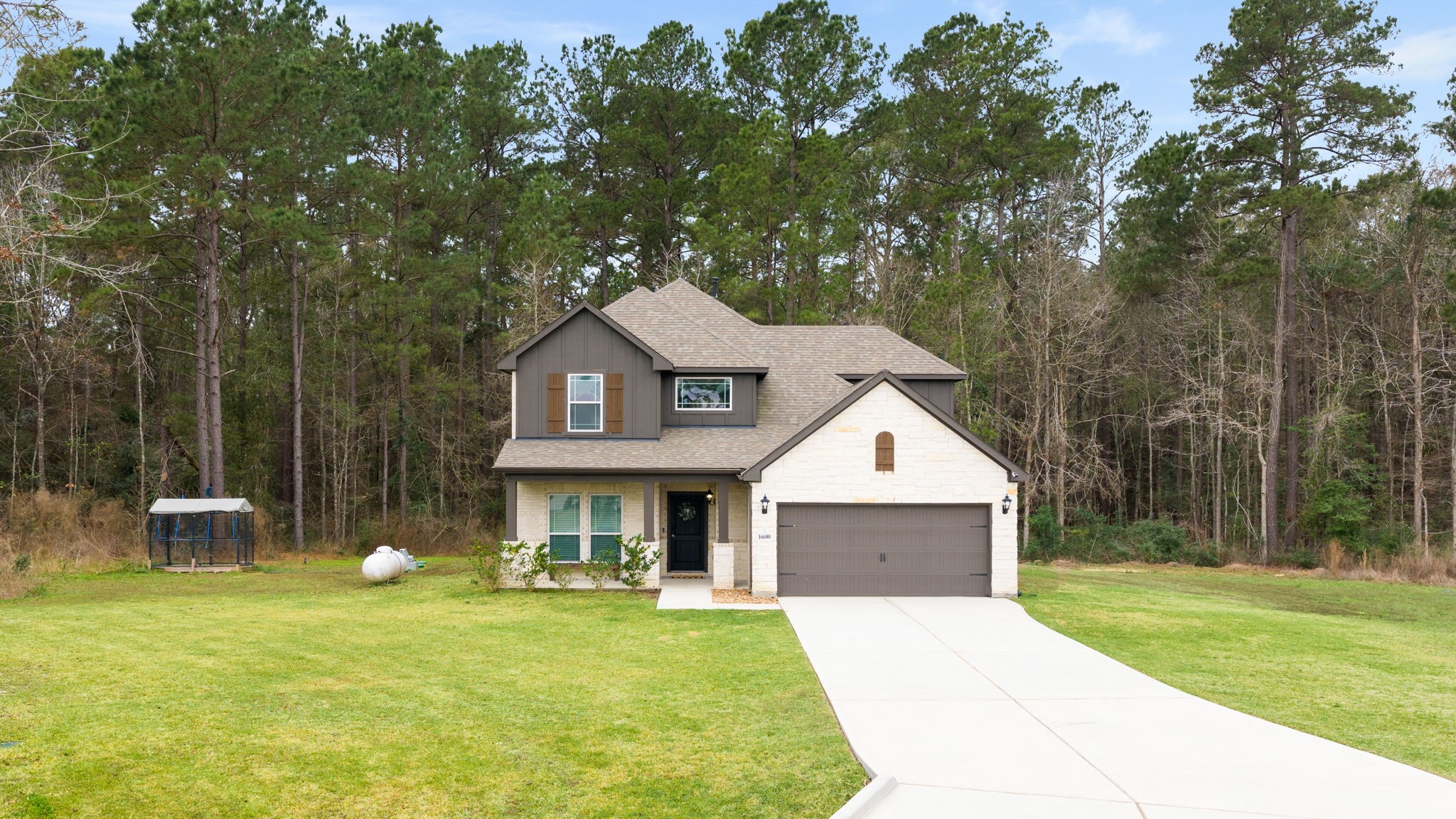 This home features an elevated CE floorplan with beautiful stone and brick front and a large covered front porch.