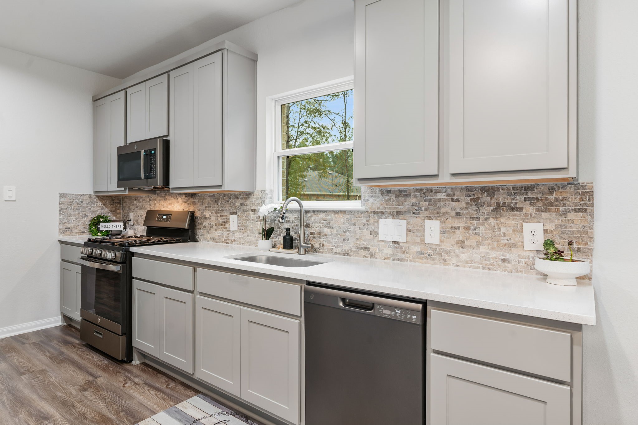 Upgraded 42" grey cabinets and a view while you do the dishes.