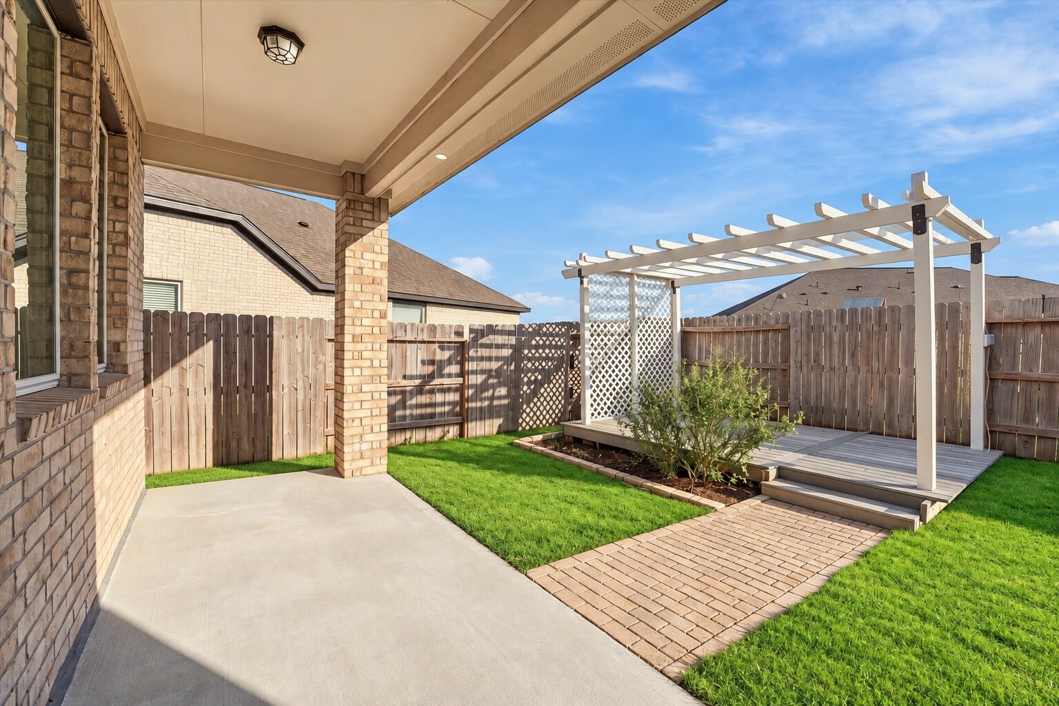 Enjoy outdoor living with a covered patio, fully fenced backyard, and charming pergola.
