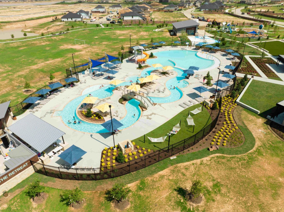 The Retreat Lazy River Amenity Village features a winding lazy river, water attractions, and poolside lounging areas for outdoor enjoyment.