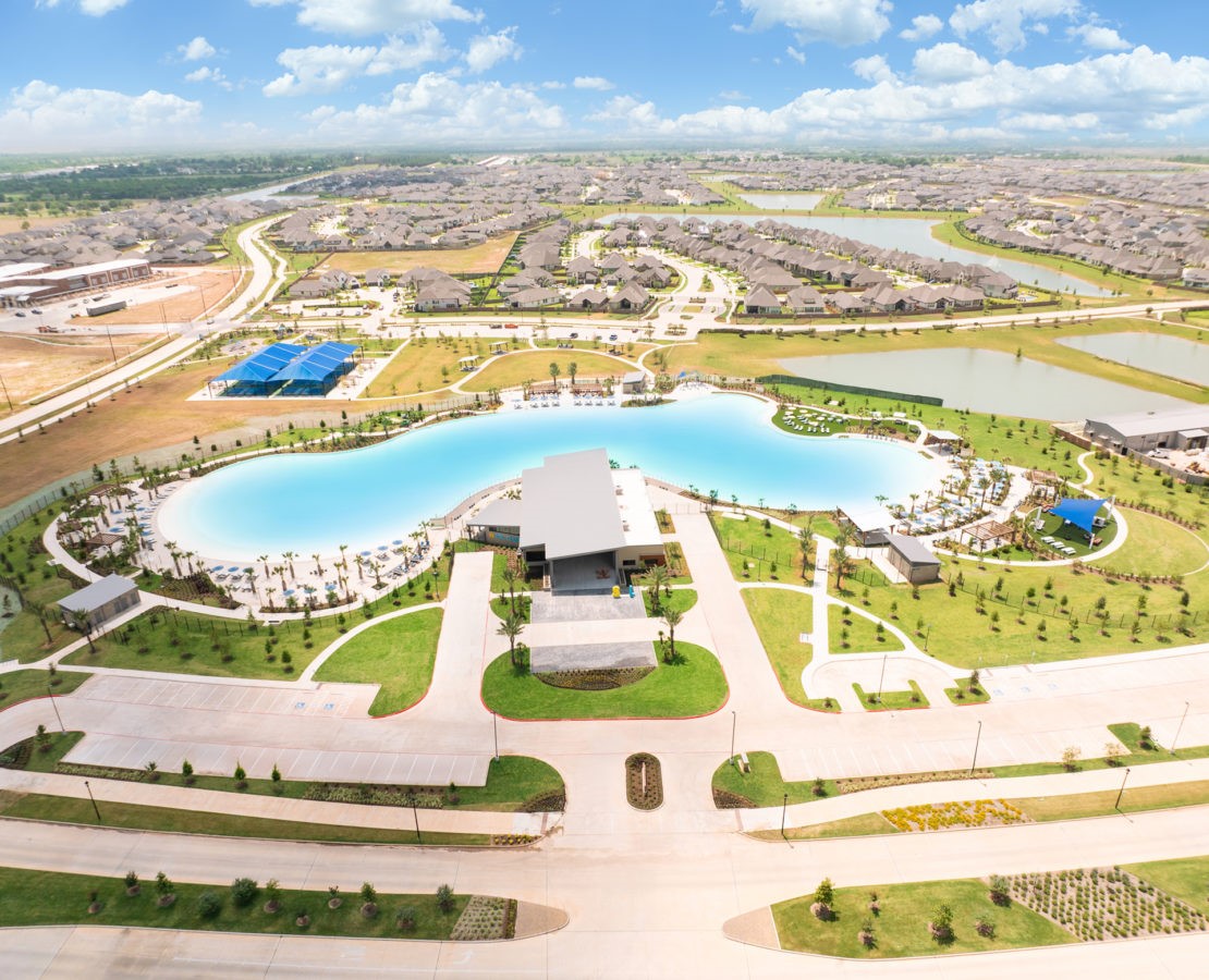Sol Club Lagoon Amenity Village offers a large lagoon-style pool surrounded by lounge areas and landscaped outdoor spaces.