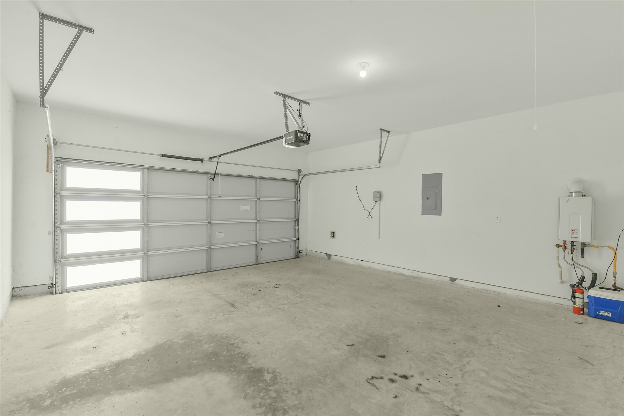 Light and bright garage with tankless water heather.