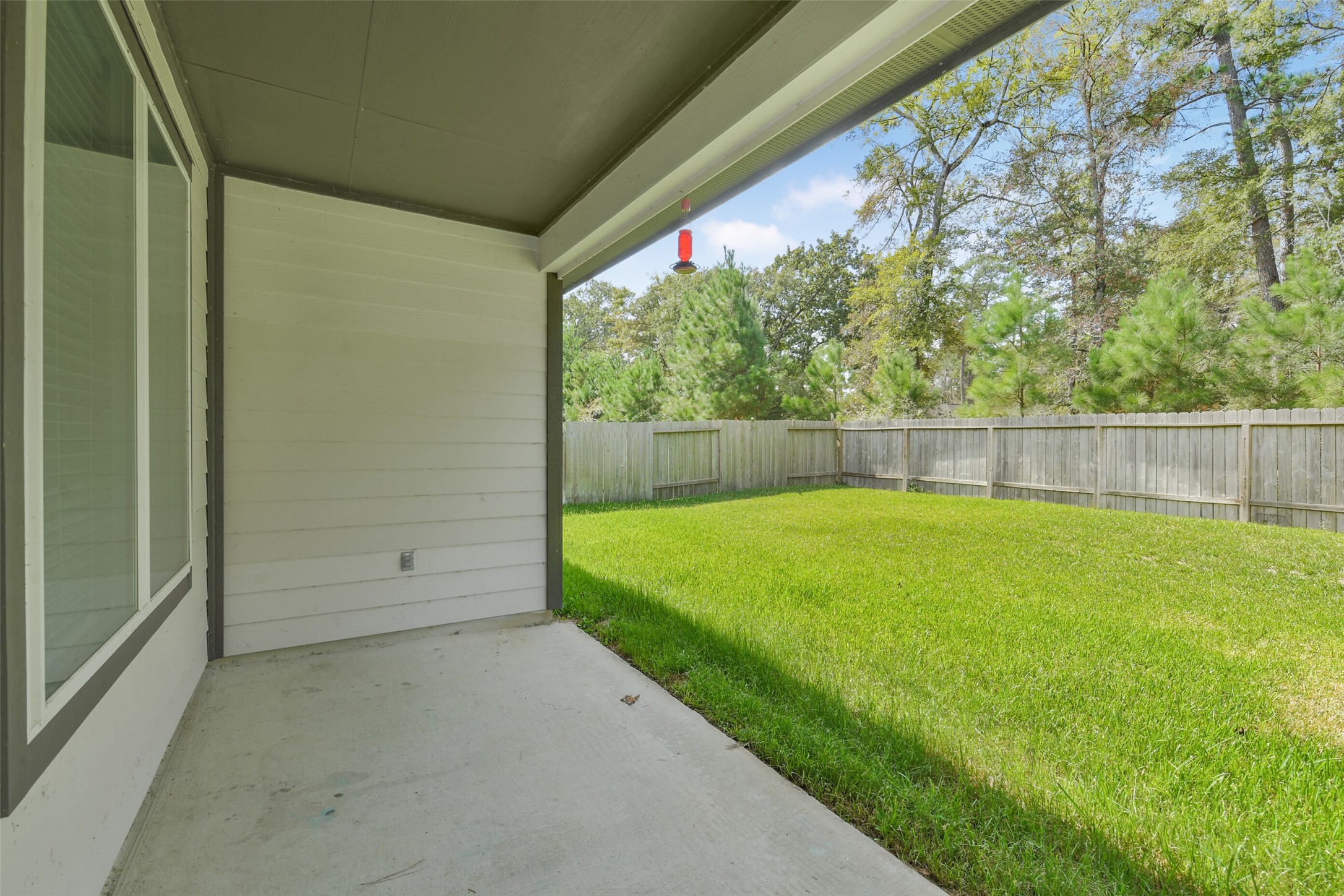 Covered patio and big back yard backing to a green belt. Covered patio and big back yard backing to a green belt.