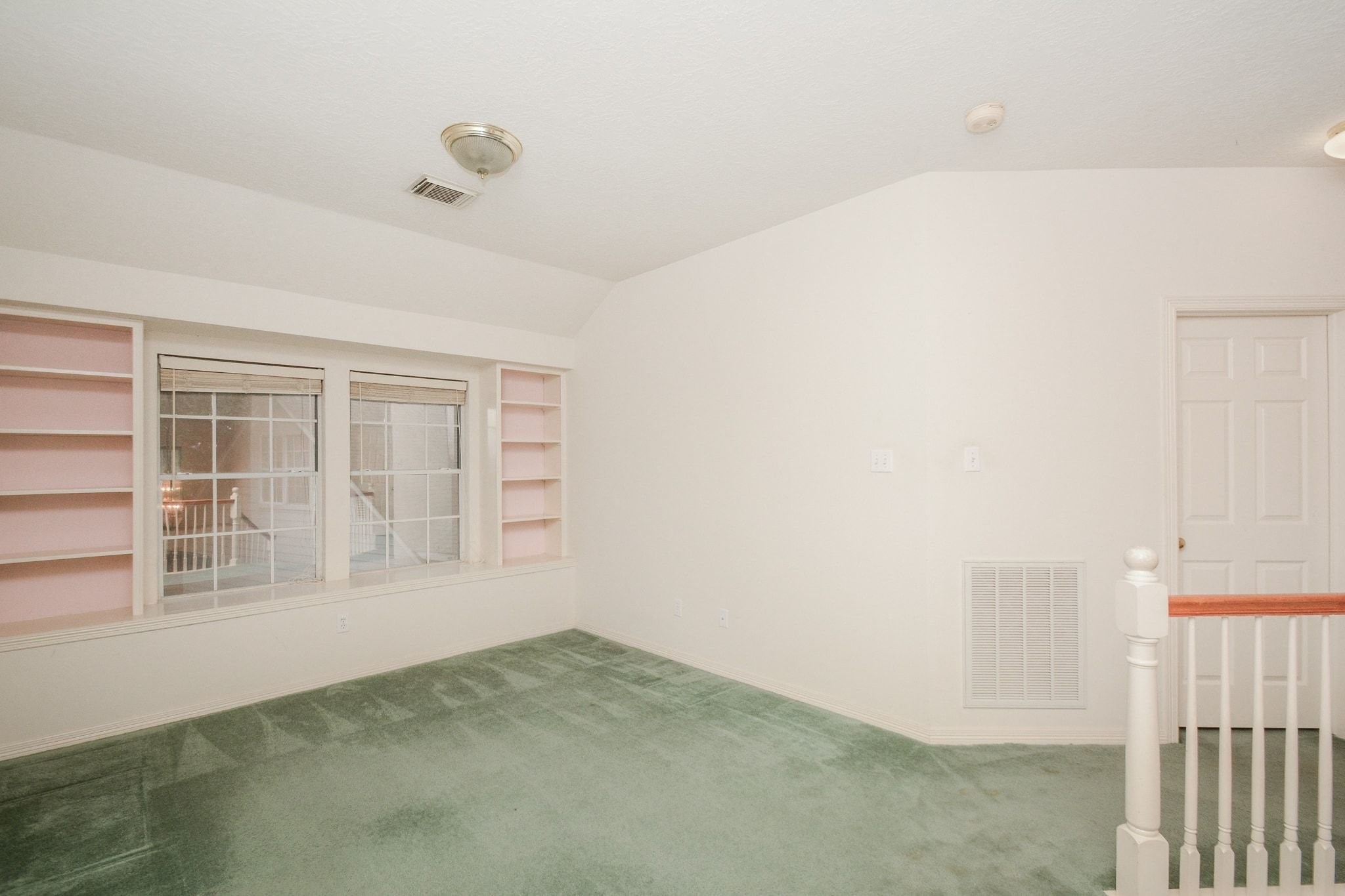 Landing area at the top of the stairs separates the primary from the secondary bedrooms