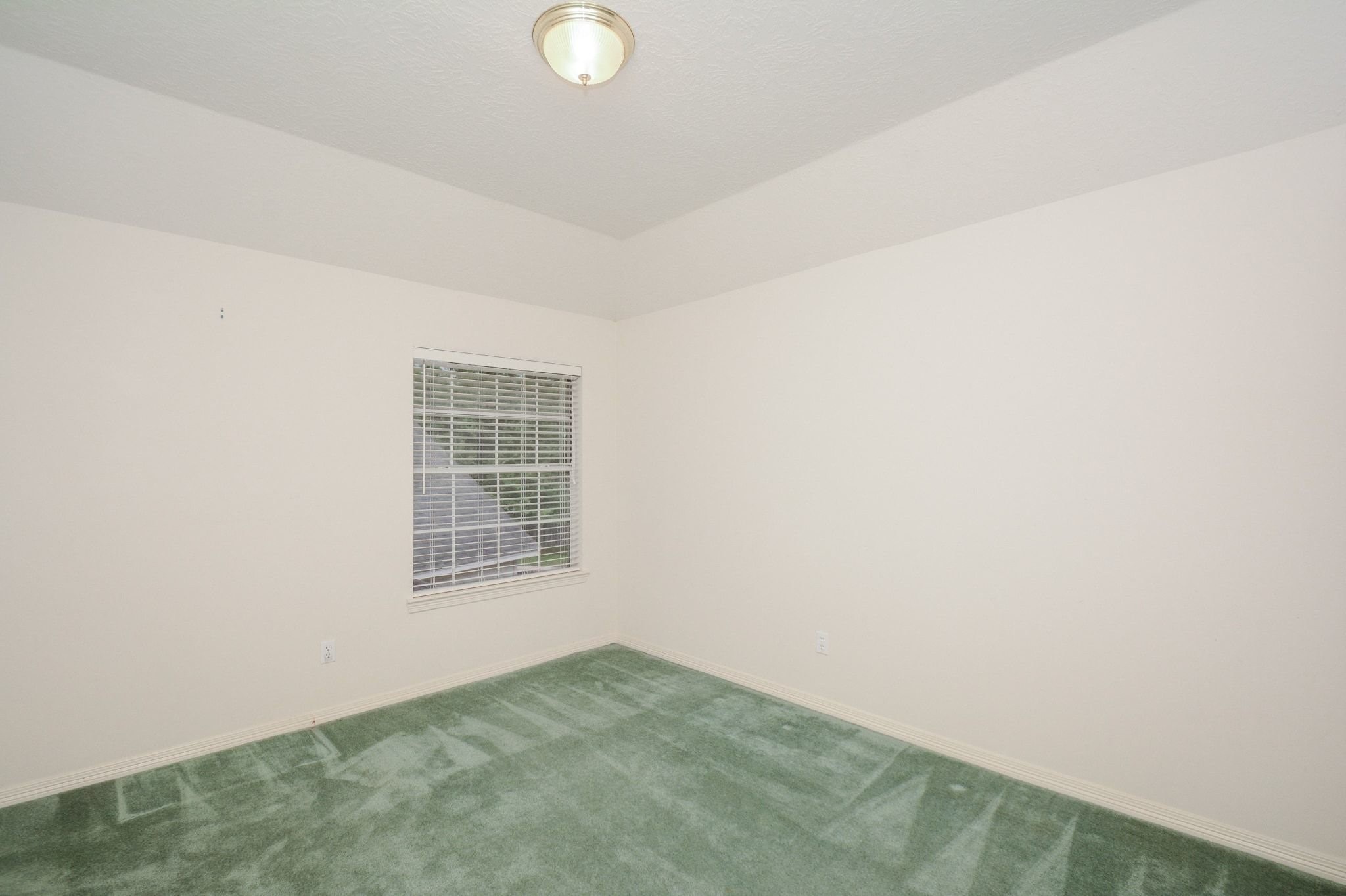 Bedroom 3 overlooks the backyard