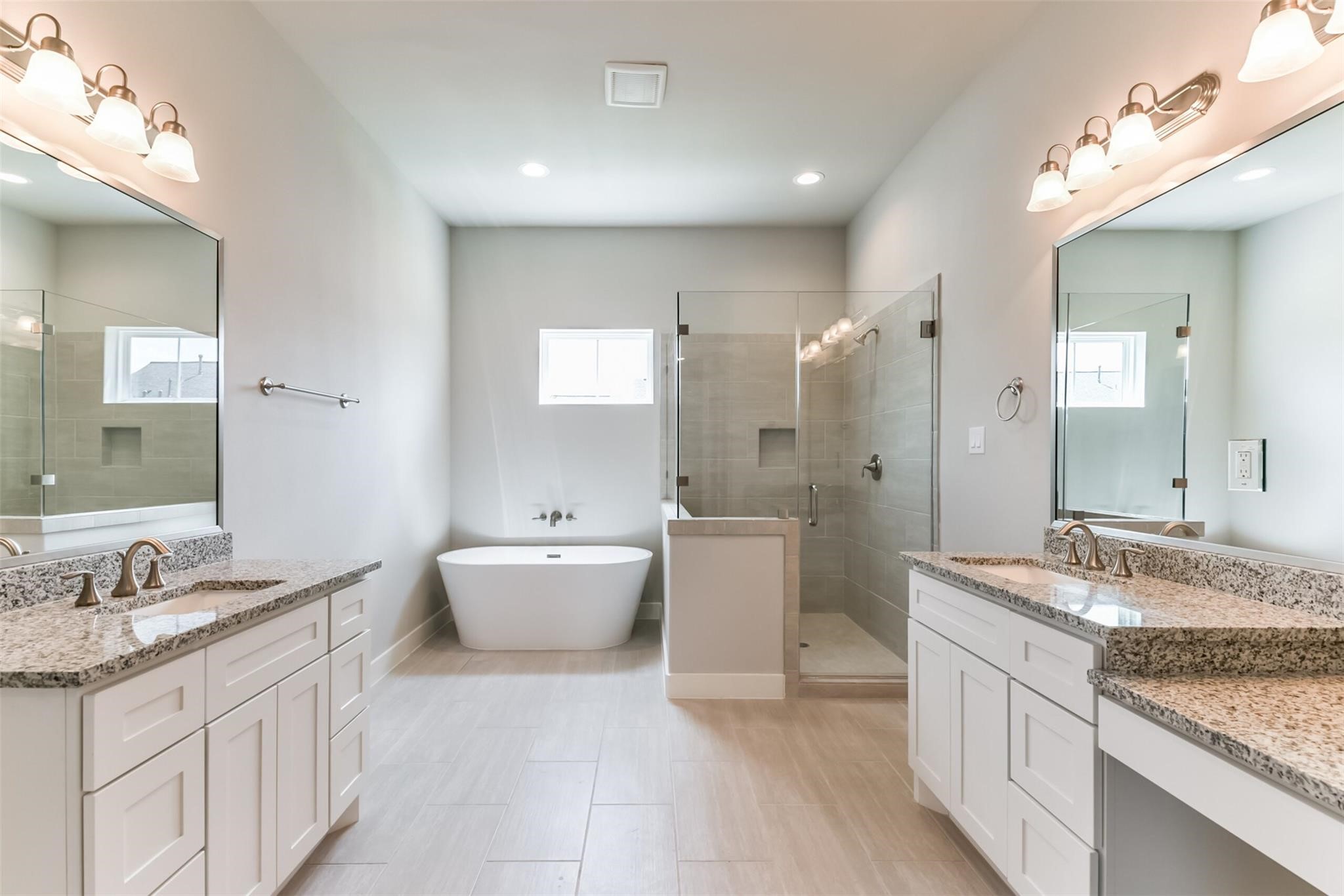 Fabulous & elegant Primary Bathroom with double vanities, frameless glass enclosed shower plus a soaking tub.