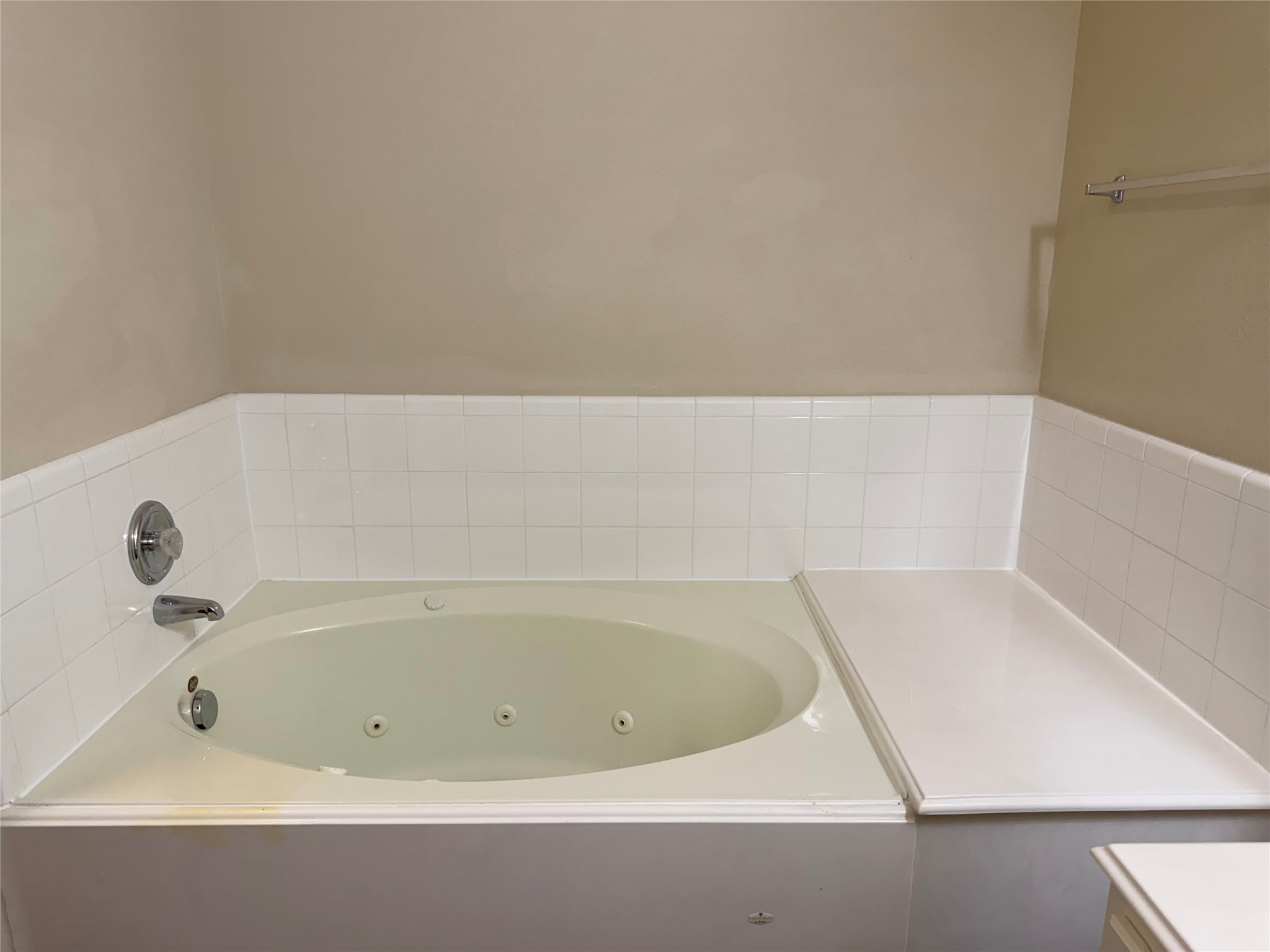 Luxurious bathtub with sleek fixtures and elegant tile surround, perfect for relaxation.