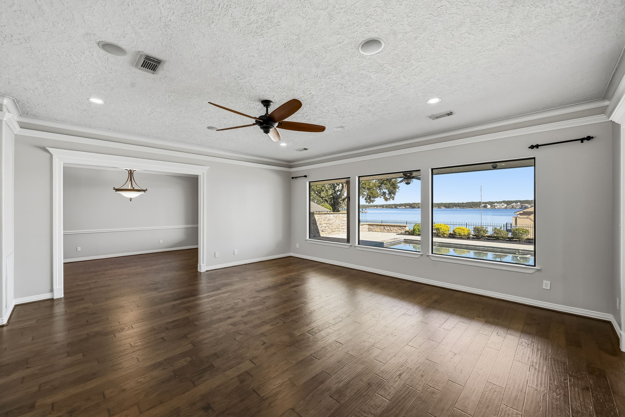 Natural light fills this inviting gathering space, where an open layout connects the living and formal dining areas.