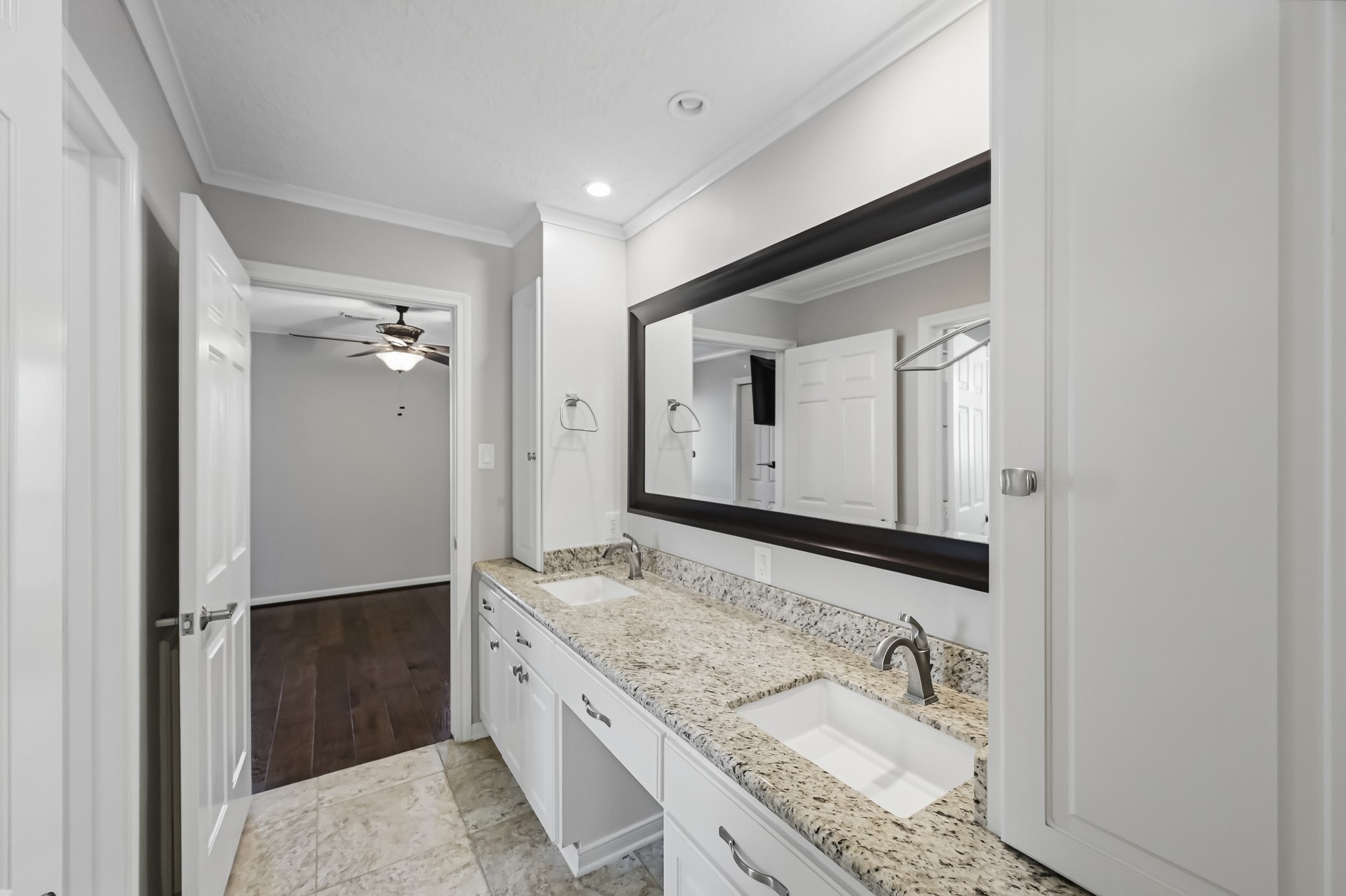 Bath #4. Jack and Jill Bathroom with an extended vanity and dual sinks, granite countertops, and white cabinetry.