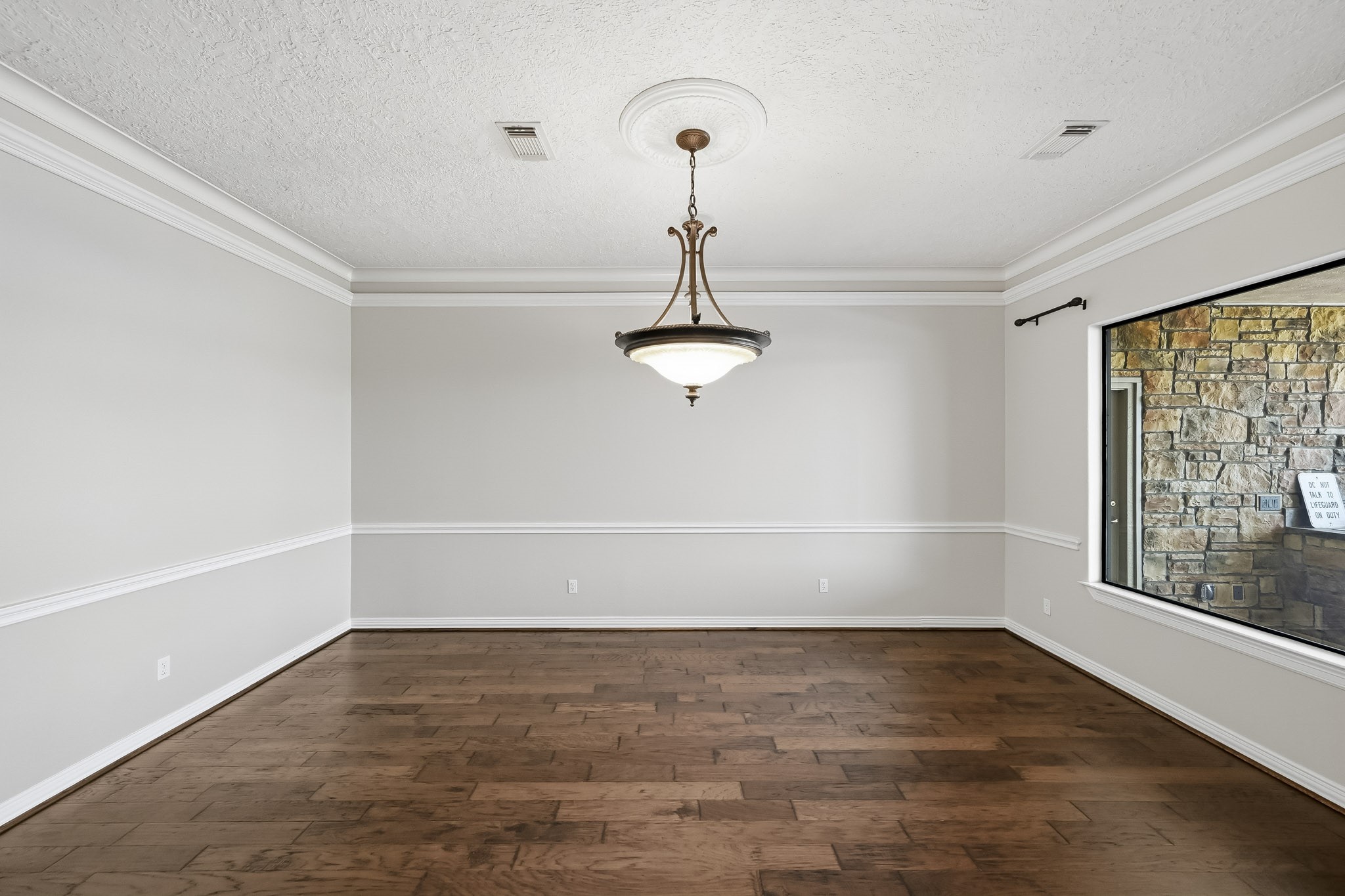 The formal dining room features crown molding, chair rail detailing and a decorative chandelier, creating an elegant setting for gatherings.