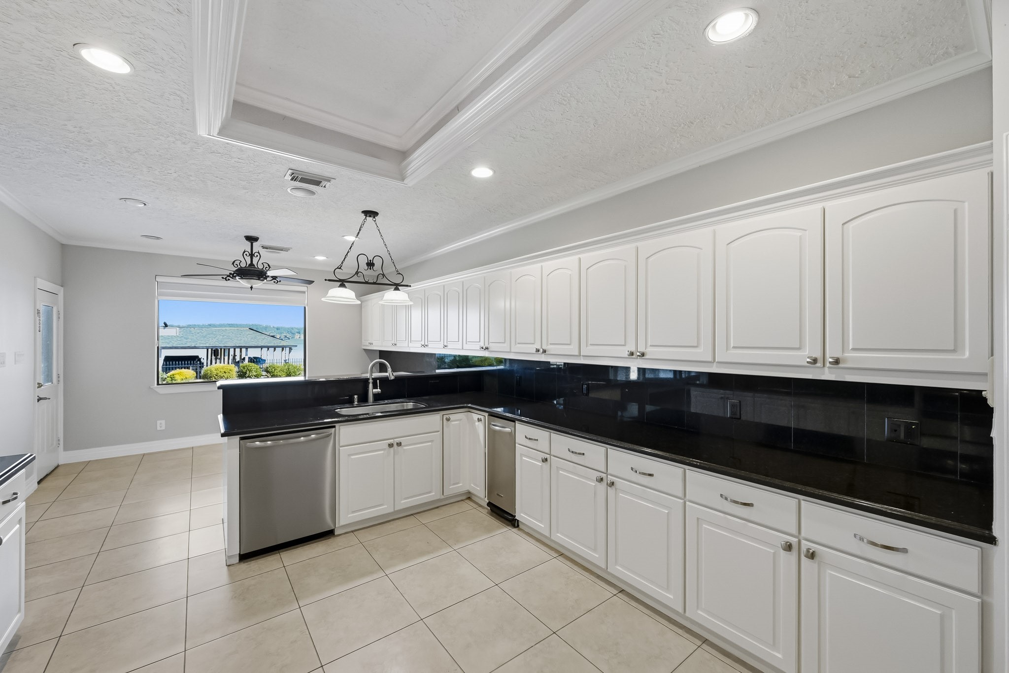 The convenient prep peninsula features an additional sink overlooking the breakfast area, creating a functional space for meal preparation.