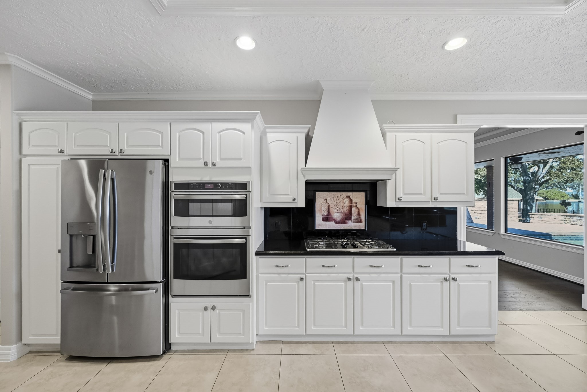 Stainless steel appliances include a French-door refrigerator, built-in microwave and oven. The refrigerator can stay!