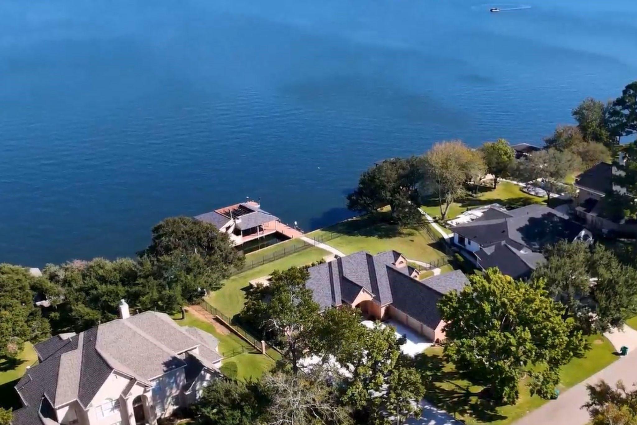 Discover the ultimate Lake Conroe lifestyle! This stunning aerial perspective showcases the home's exceptional peninsula setting, waterfront location and impressive outdoor amenities. Schedule your private showing today!