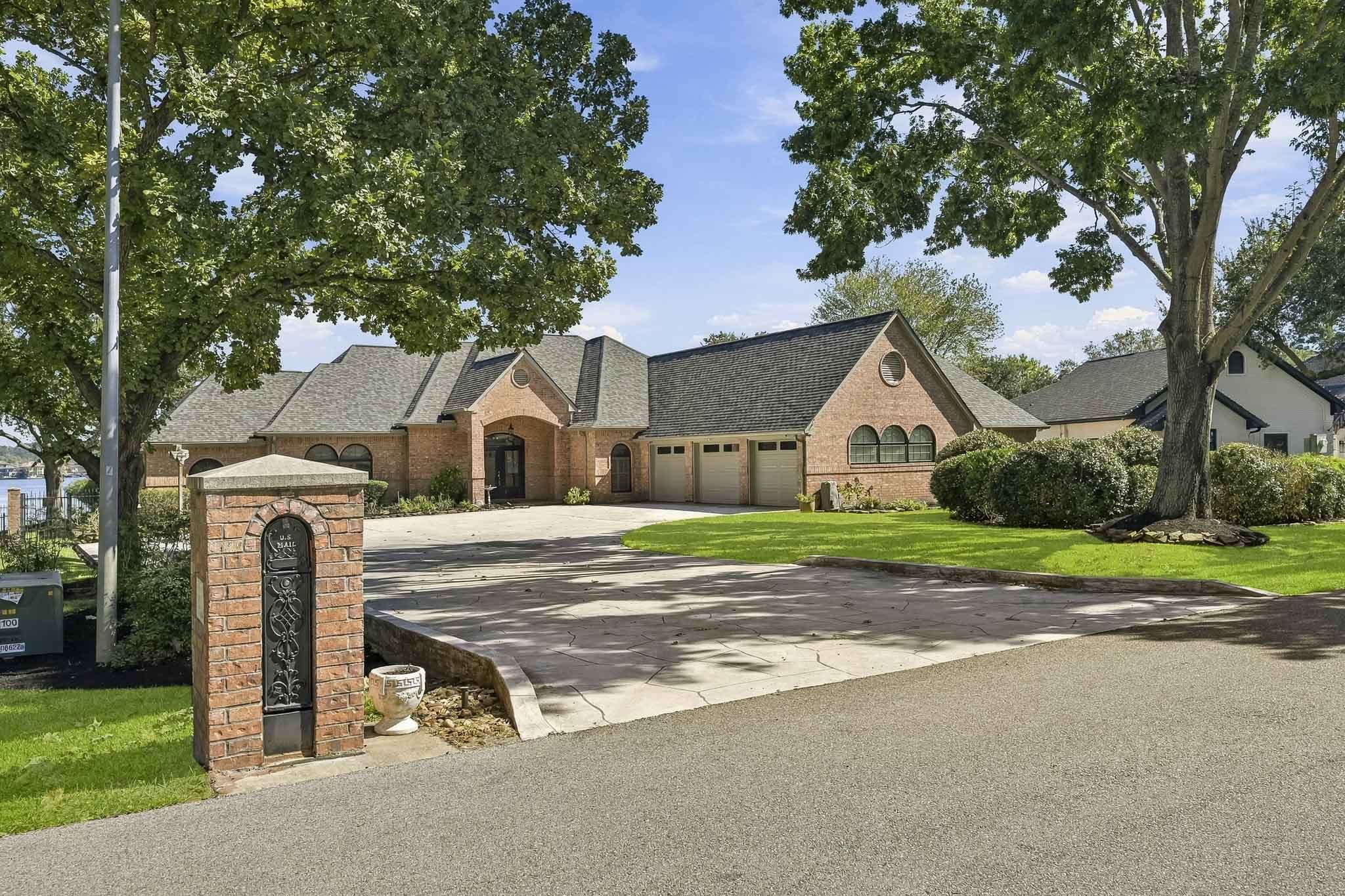Secluded custom waterfront retreat on a Lake Conroe peninsula in gated Rancho Escondido, positioned on the coveted east sunrise side for spectacular open-water views and refreshing lake breezes!