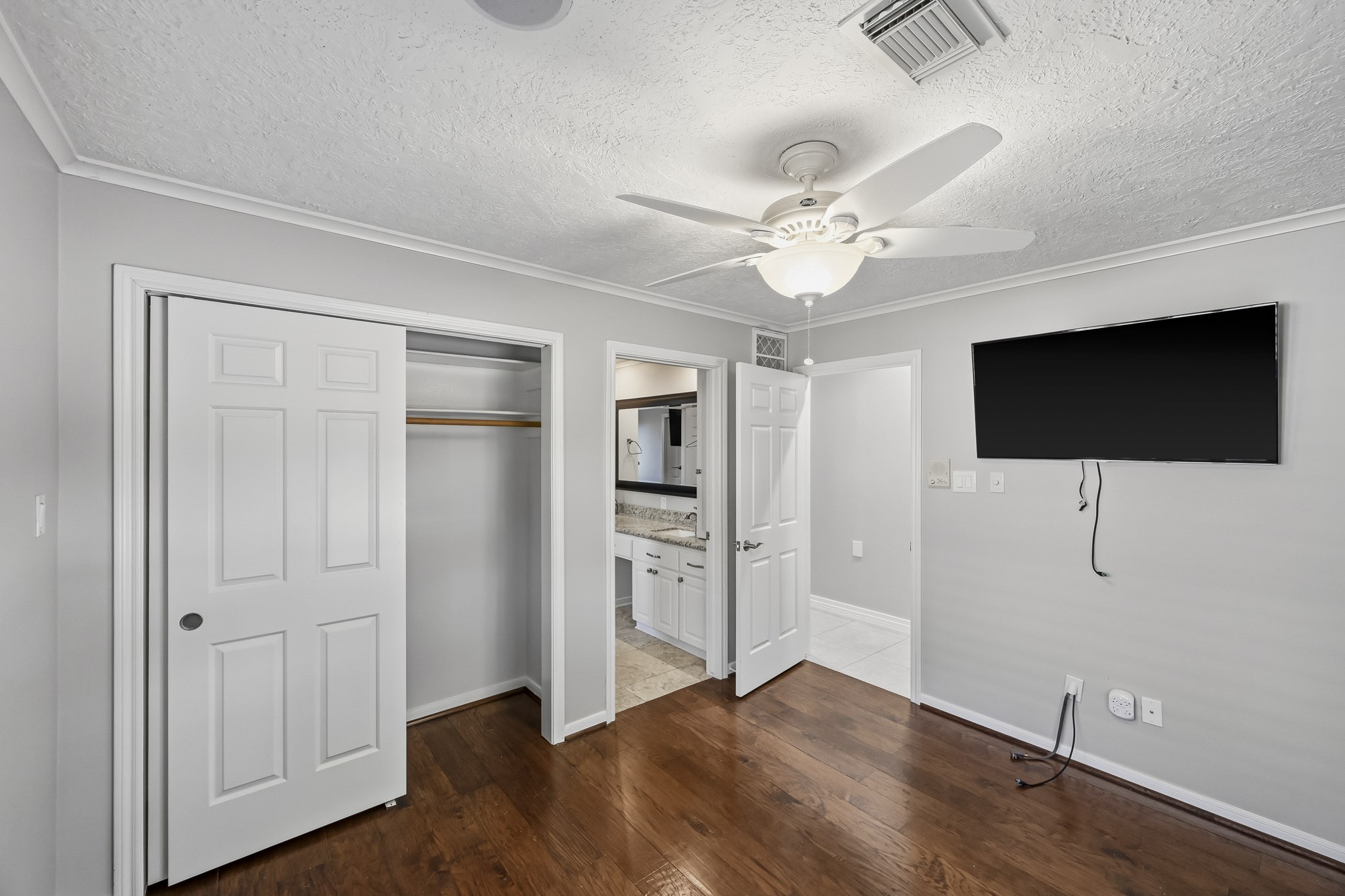 Bedroom #3. Another perspective highlights the bedroom's closet space and convenient access to the adjoining bathroom.