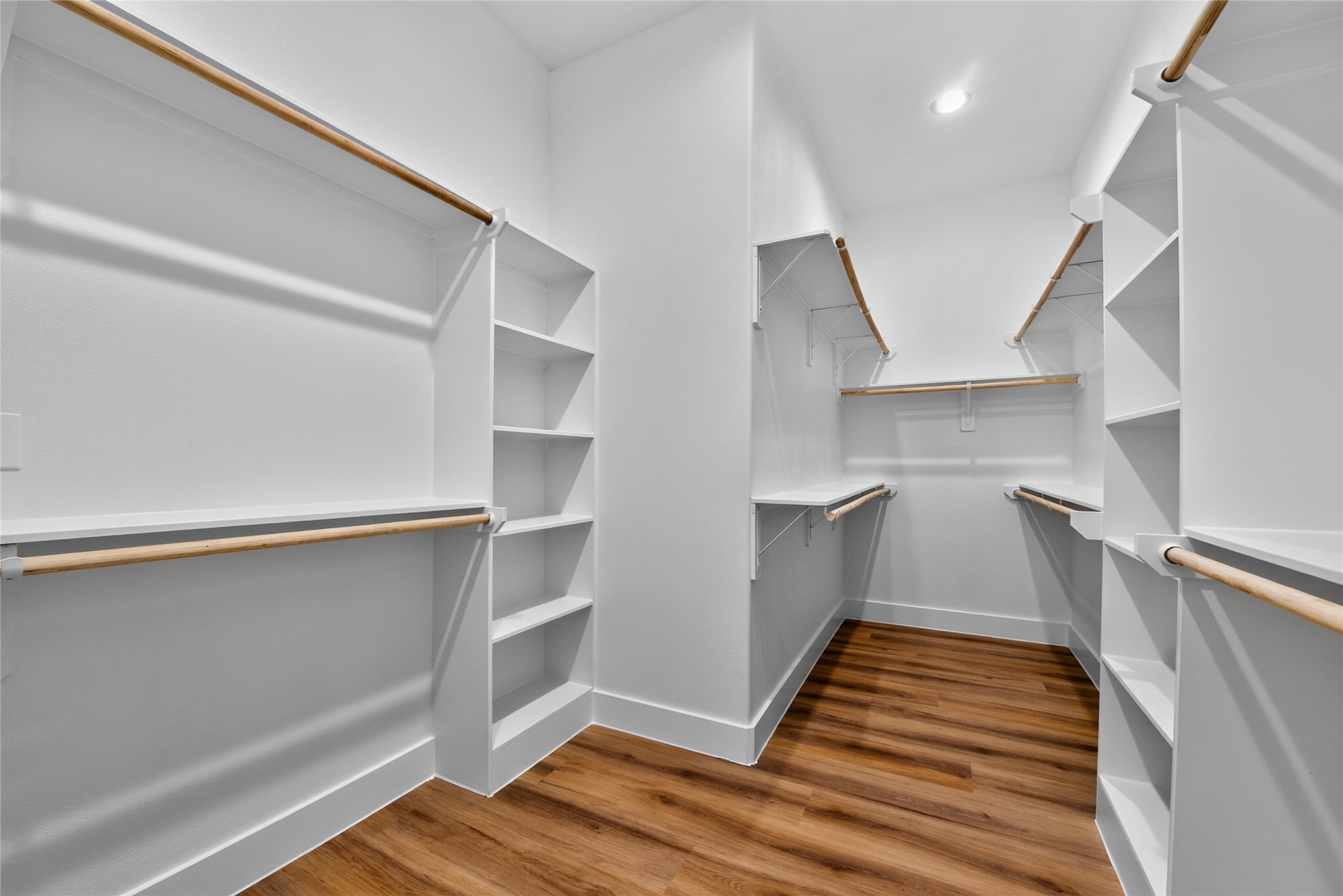 A spacious primary closet with walls of storage spacebeautifully organized, generously sized, and designed to keep everything in place.