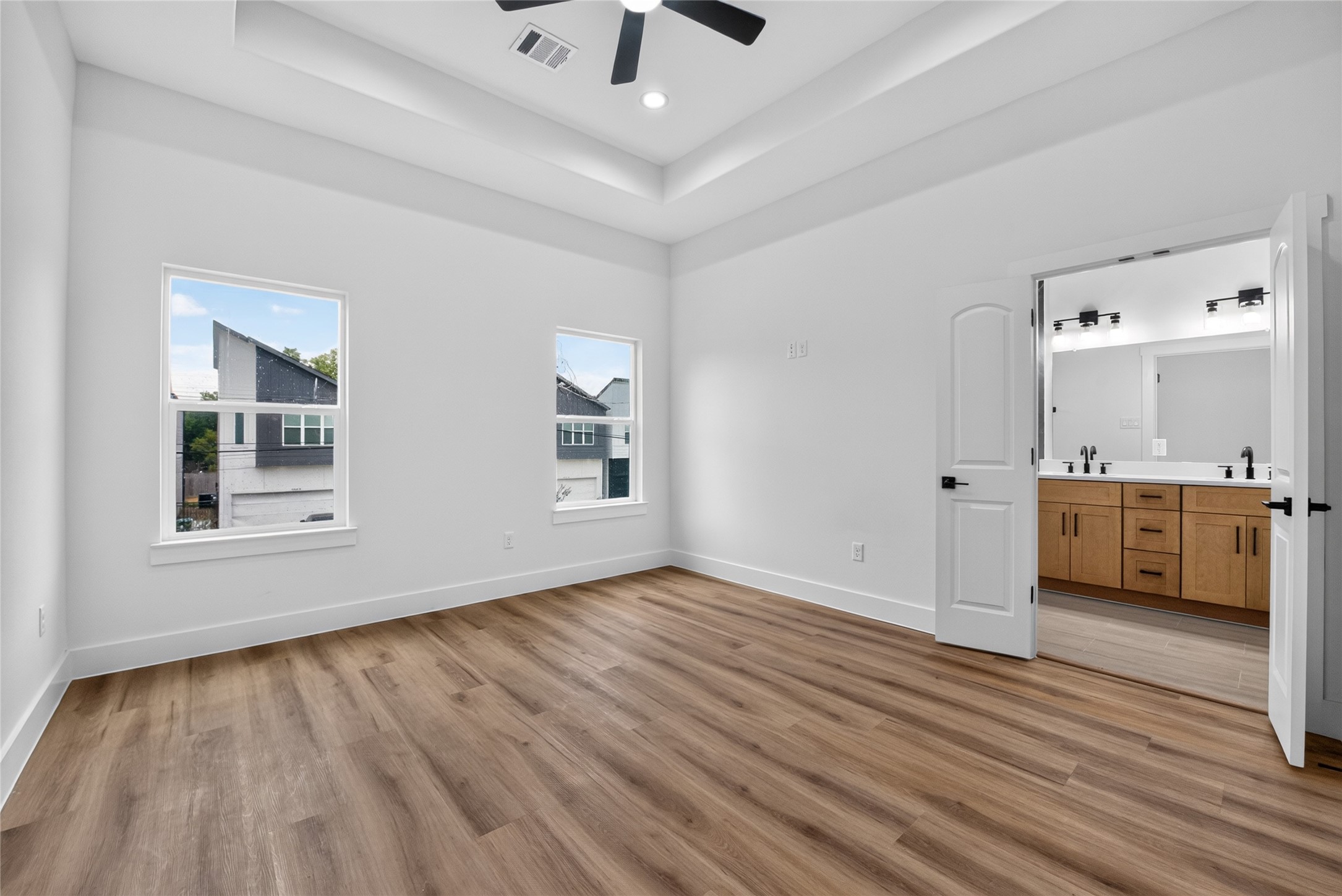 Another view of the spacious primary suite, showcasing its bright, inviting atmosphere and comfortable proportions.