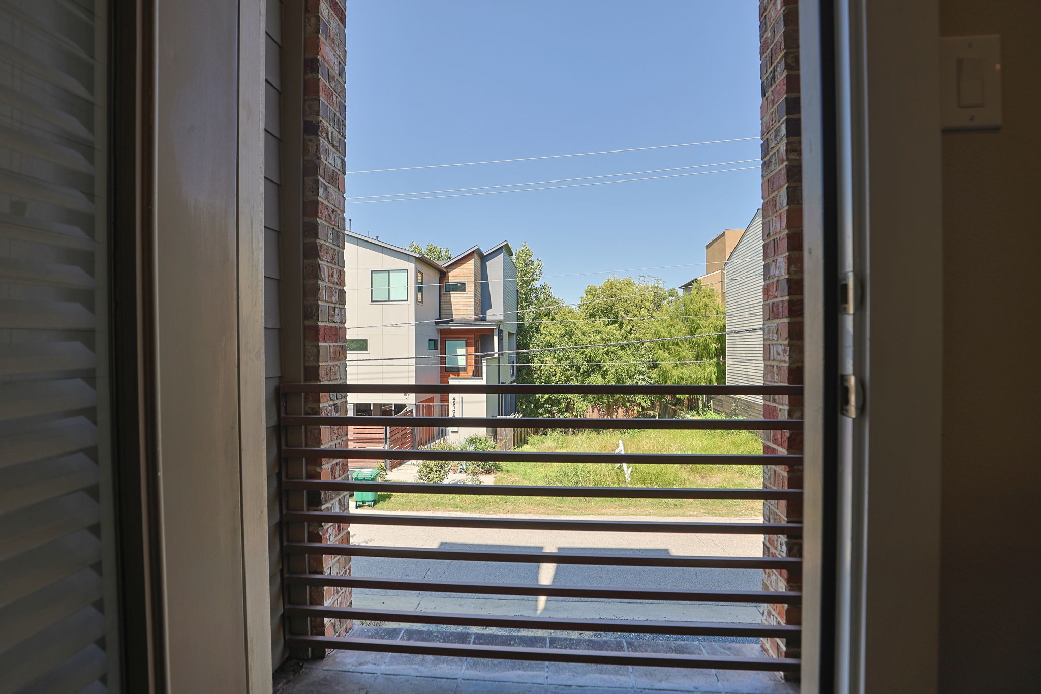 2nd floor balcony has a view of the trees across the street. Room for a bistro table to relax at sunset.