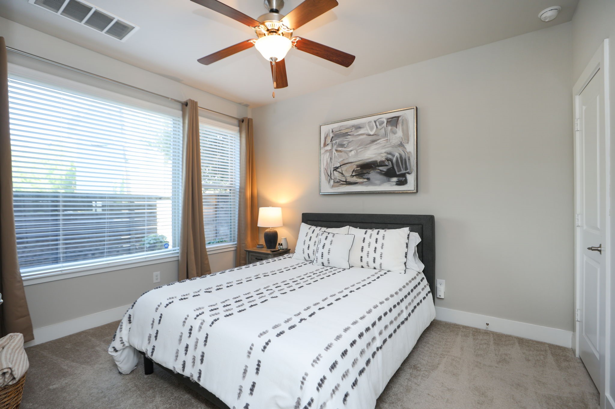 First floor room has large windows overlooking the private patio, as well as a large closet and private bath.