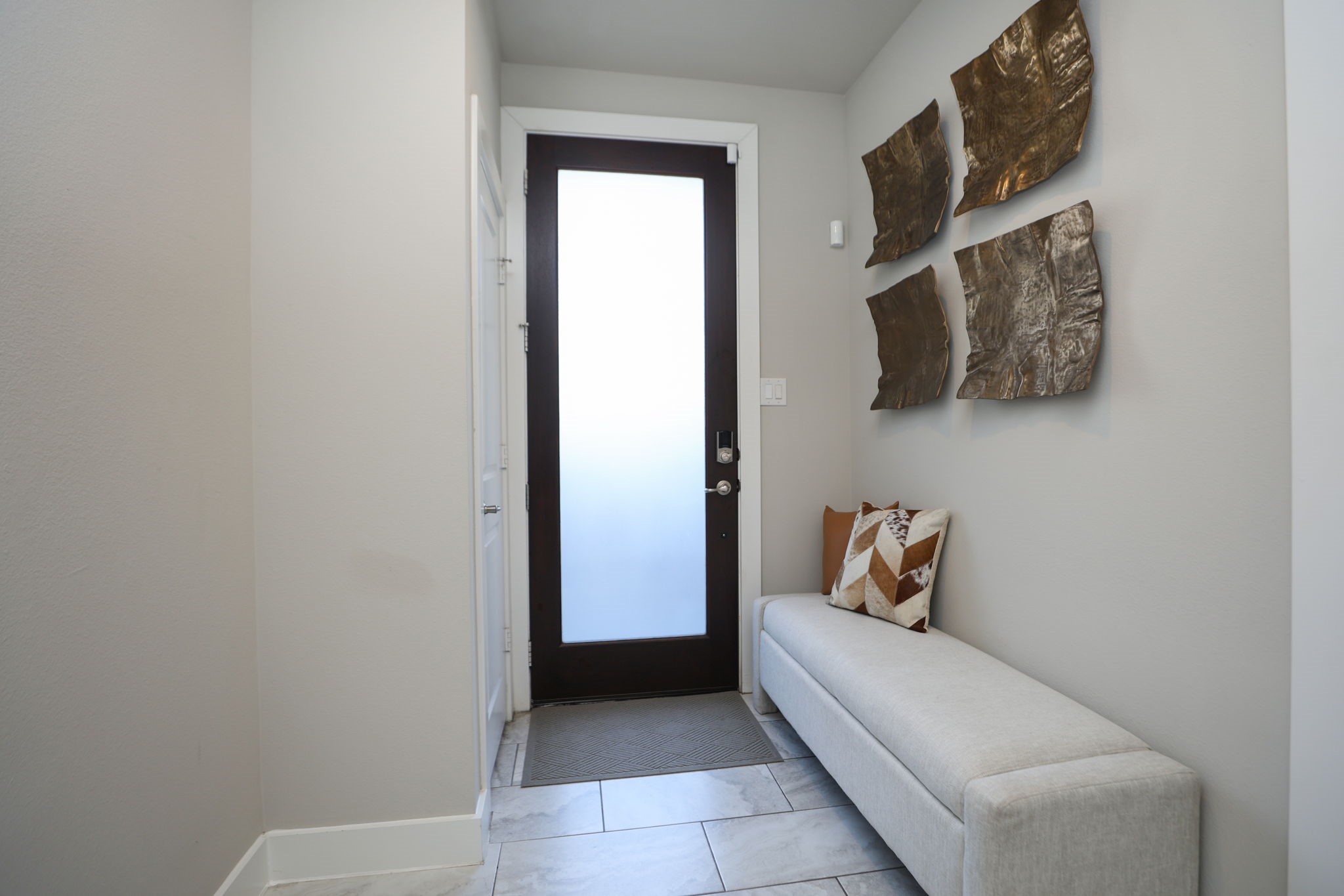 View back towards the front door with coat closet to your left and room to sit and put on your shoes to the right. Also plenty of room for a "drop spot"!