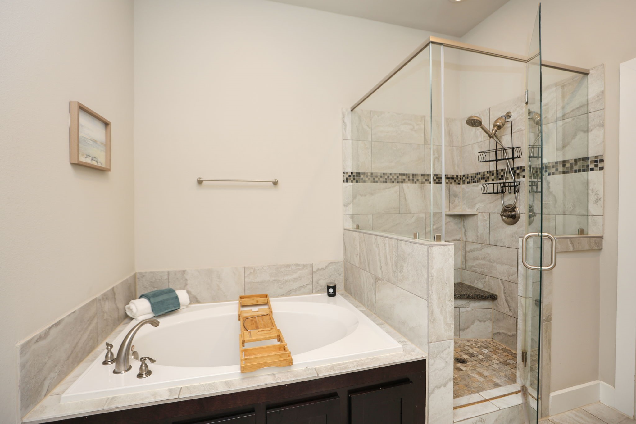 Separate shower and soaking tub, as well as a private toilet room (not photographed). Modern tile in every bathroom!