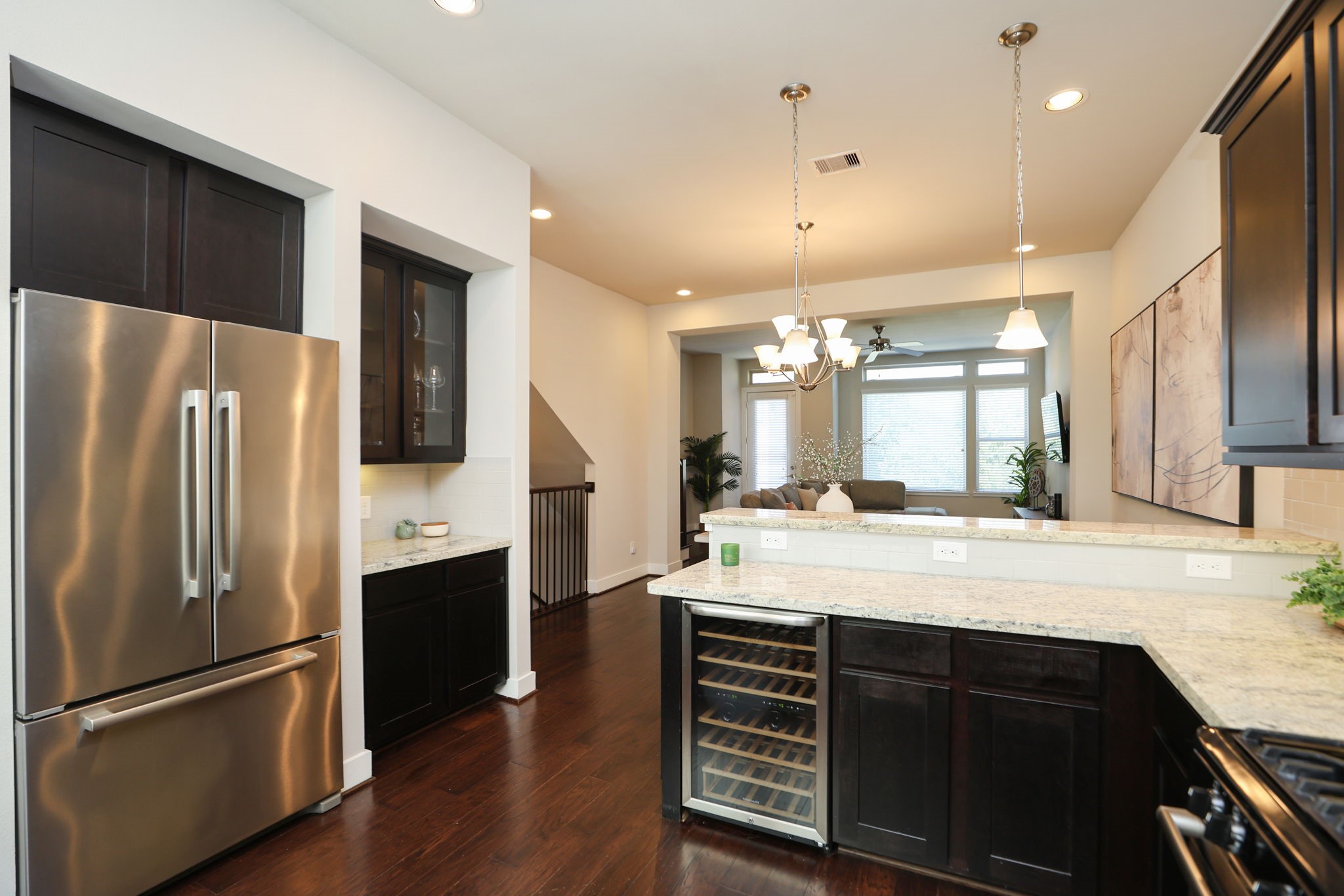 View back across your open living area. Greet guests as they come up the stairs (to the left) and relax at the raised island.