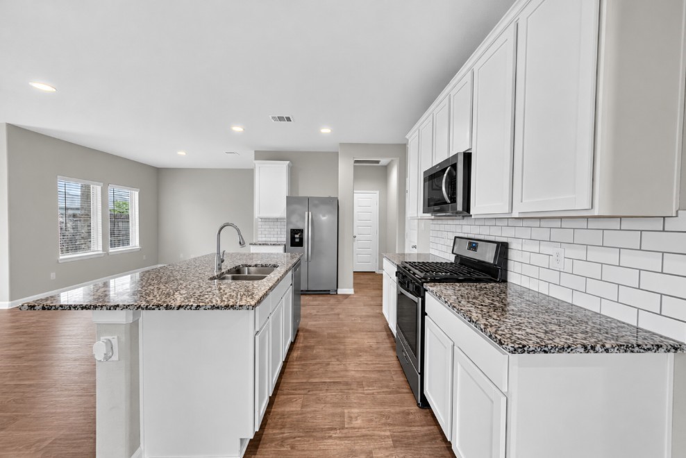 Close-up showcasing the beautiful countertops and coordinating backsplash.