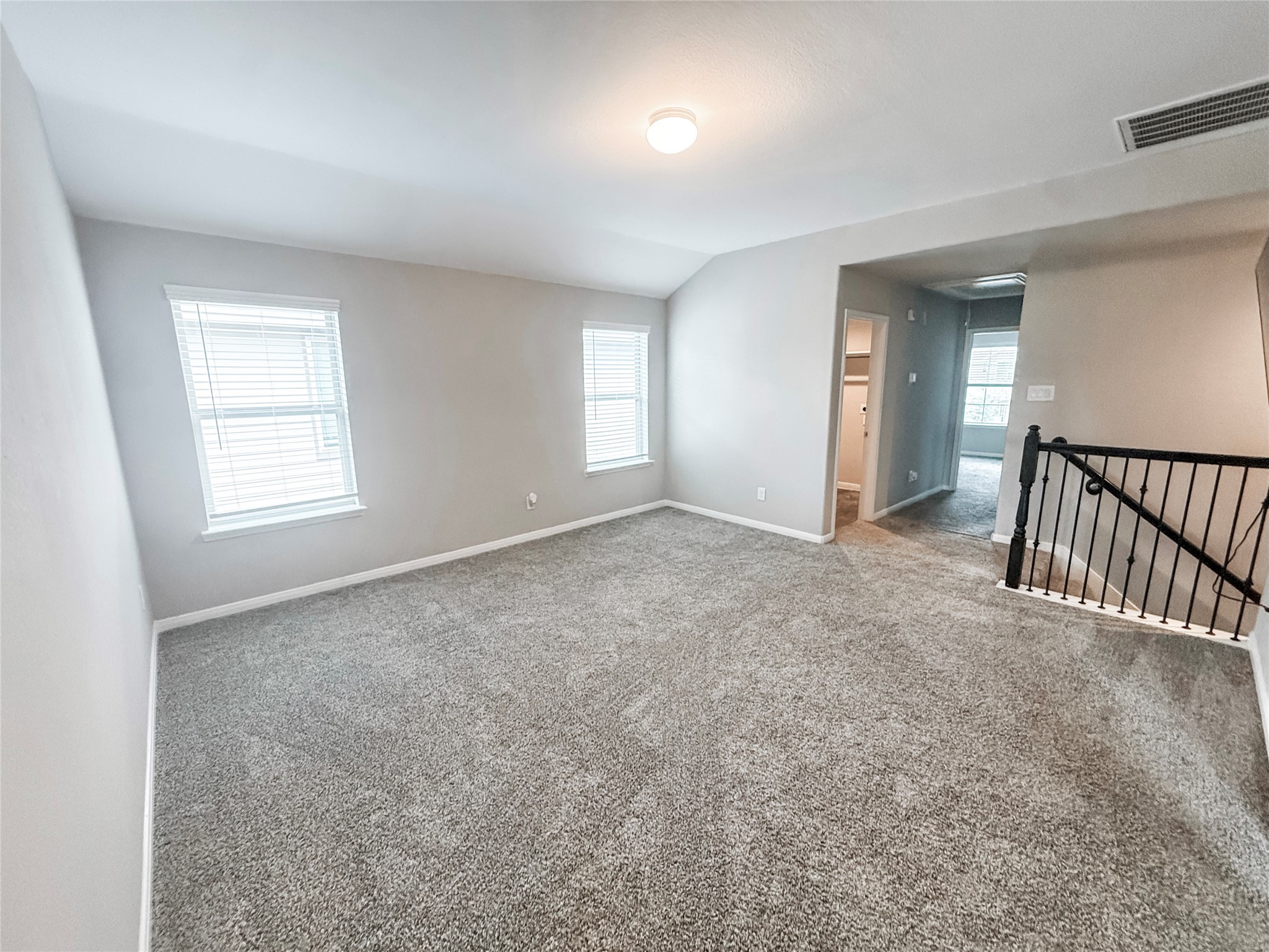 Spacious upstairs game room leading to the laundry room on the left, two additonal secondary bedrooms and the secondary full bath.