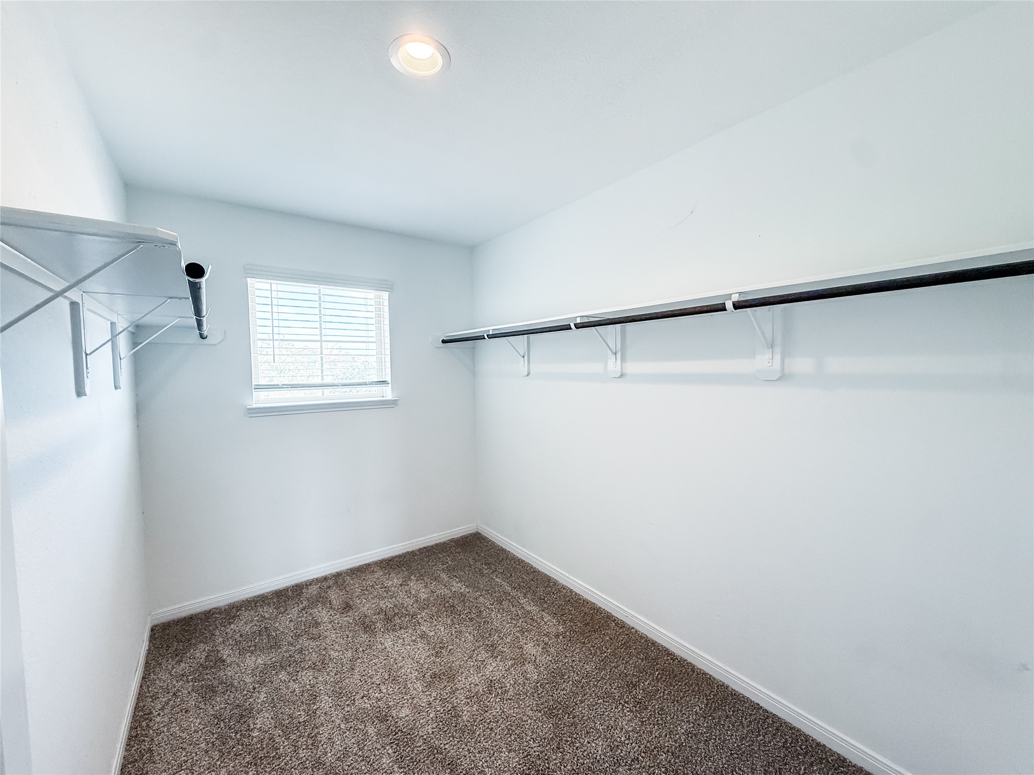 Spacious walk-in closet with plenty of storage space.
